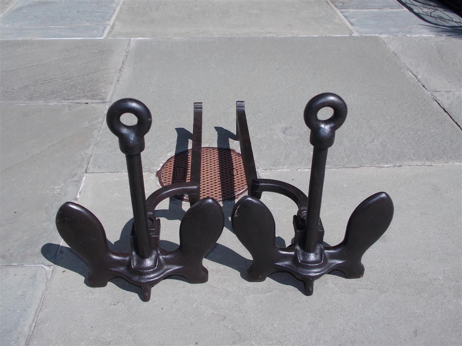 Pair of American cast iron anchor andirons with circular ringed columns, squared plinths, and the original dog legs. Late 19th century.