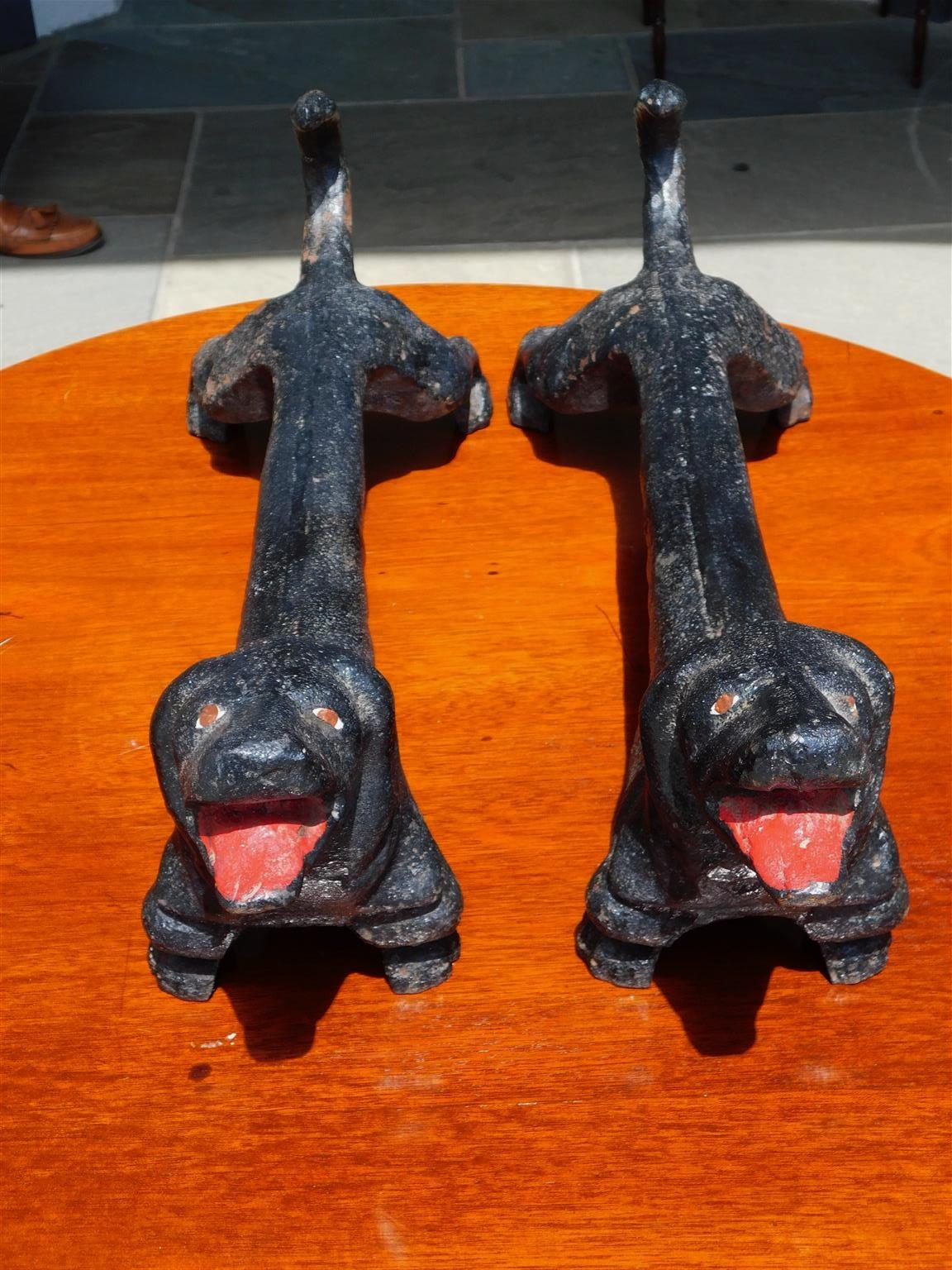 Pair of American cast iron dachshund fire place andirons with painted eyes, mouth, and curled tails. Late 19th century.