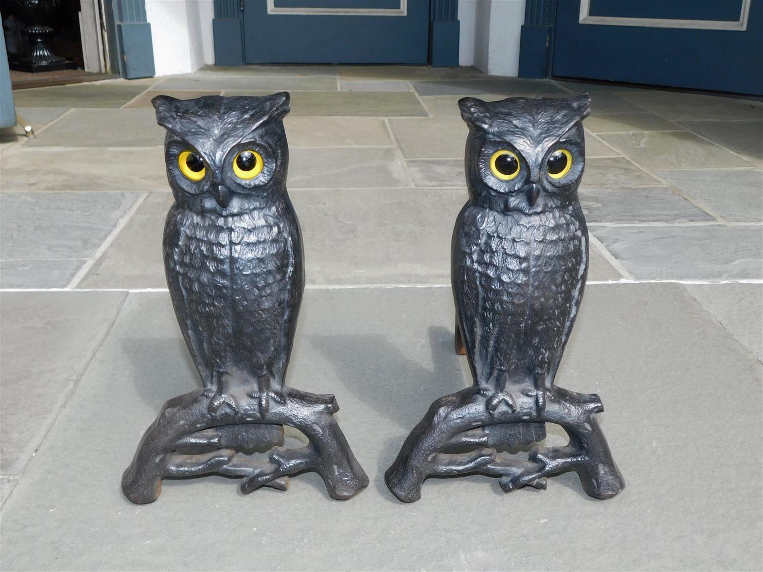 Pair of American cast iron perched owl andirons with original glass eyes and rear dog legs. Boston, MA, Late 19th century.
