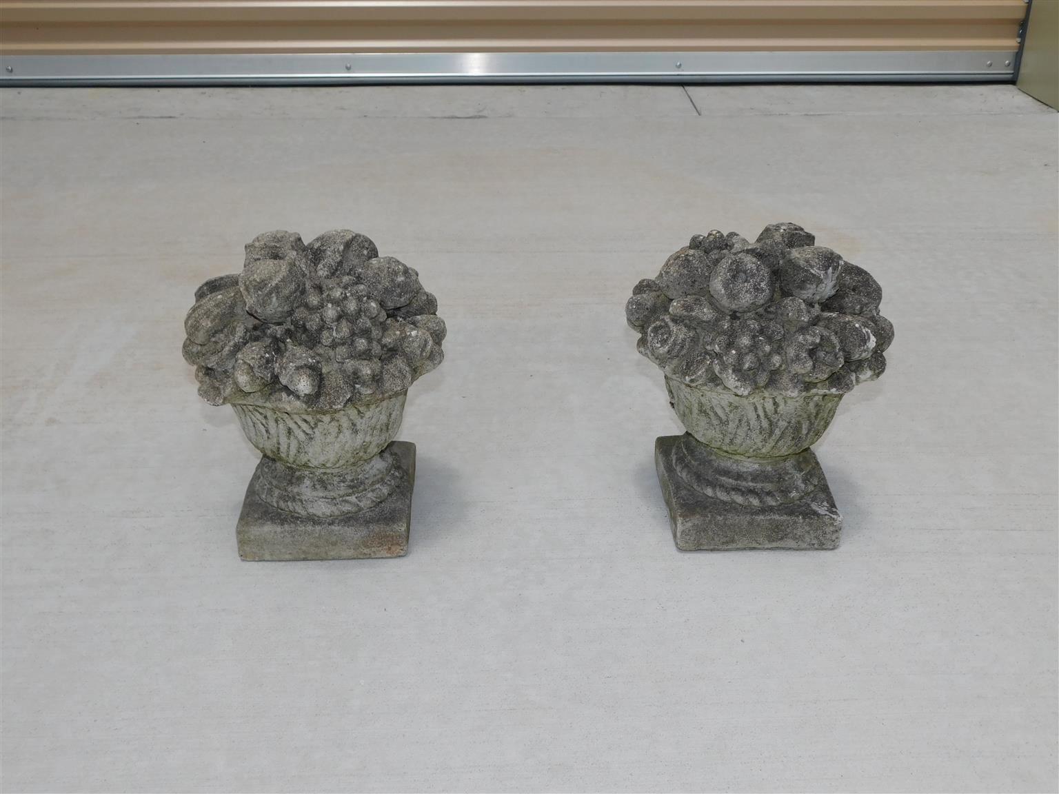 Pair of American cast stone flower and fruit baskets on squared plinths, Late 19th Century