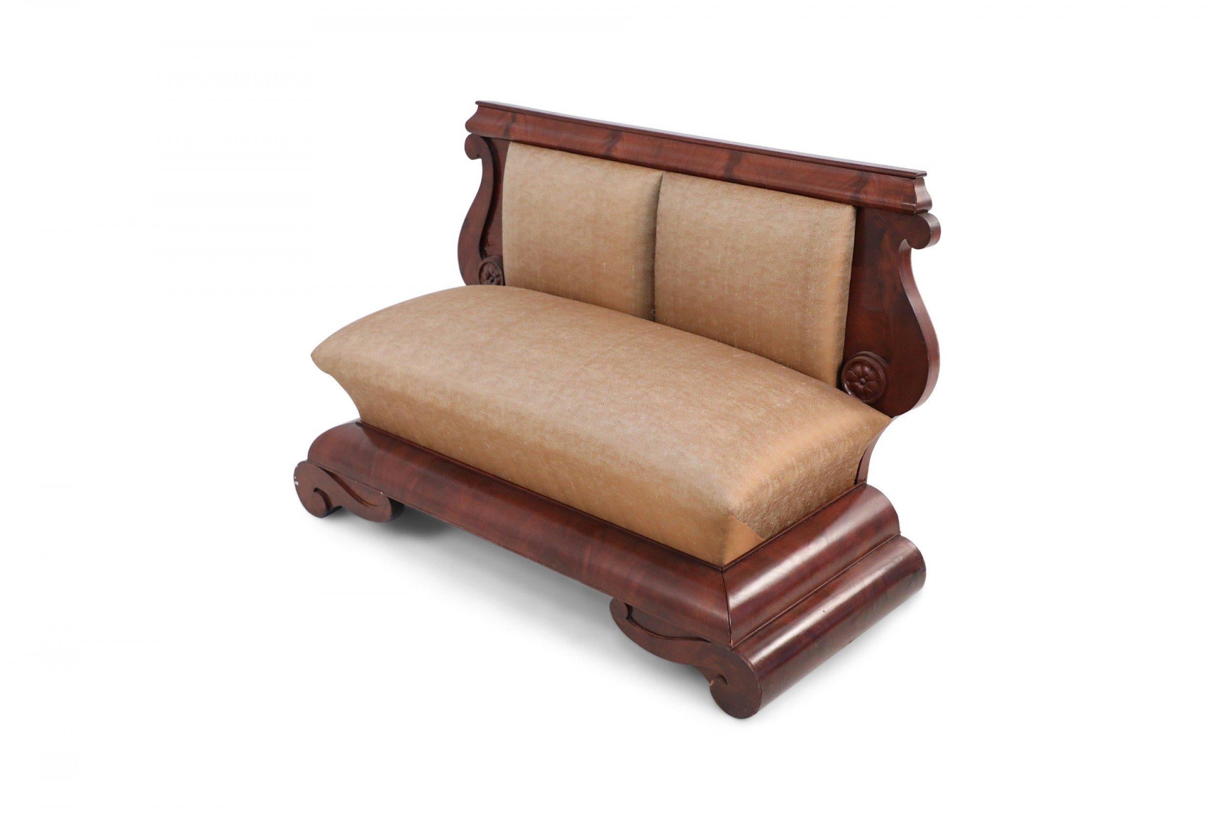 Pair of American Empire (circa 1840) window seats with crotch mahogany veneer frames, lyre-shaped backs, and beige satin upholstered seat & back resting on large tiered base.