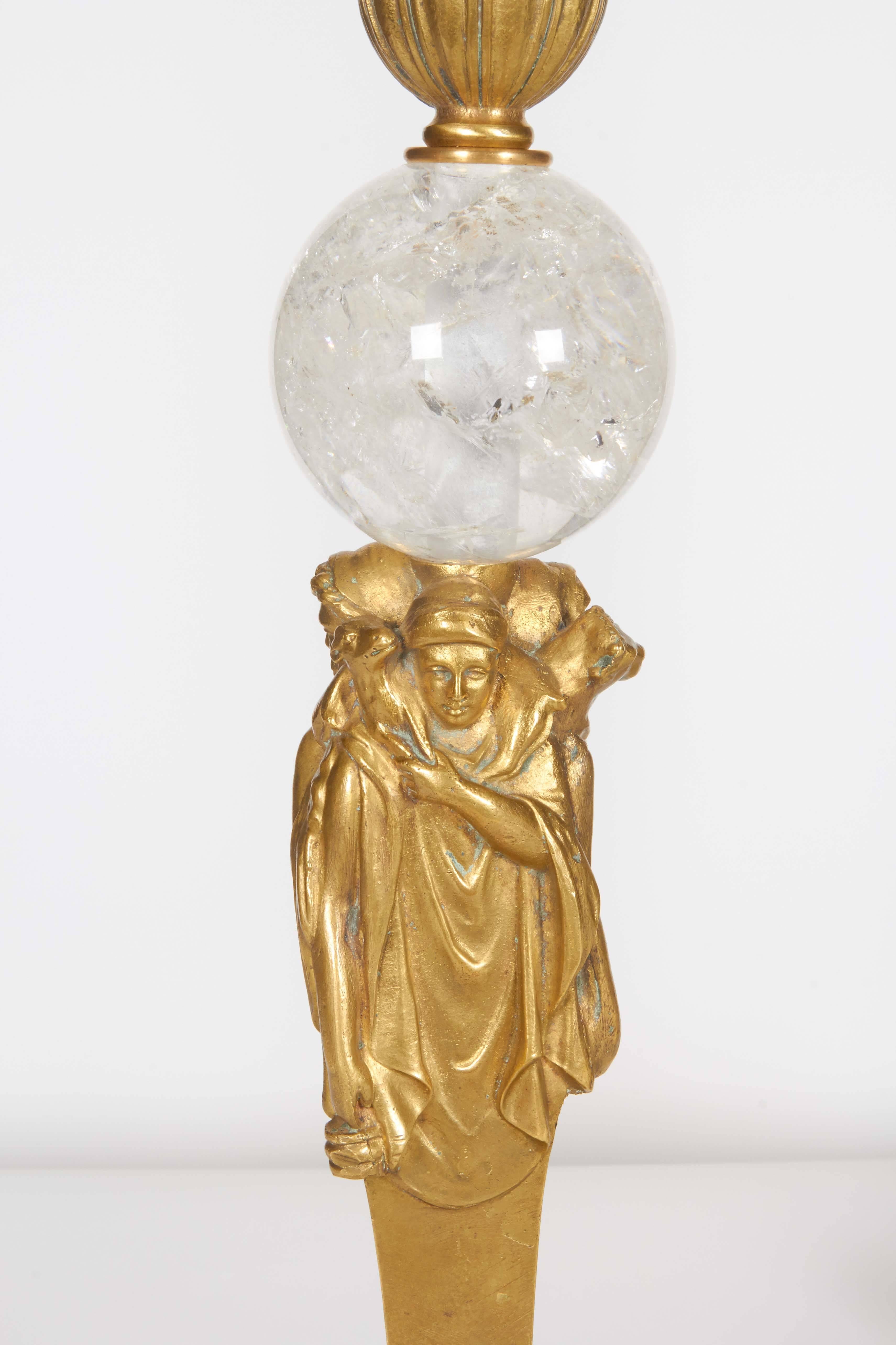 Pair of American gilt bronze and rock crystal table lamps by Edward F. Caldwell and Co.

Modeled with three figures on a tripod base with masks on paw feet.

The underside of one stamped with a C within a lozenge.

17