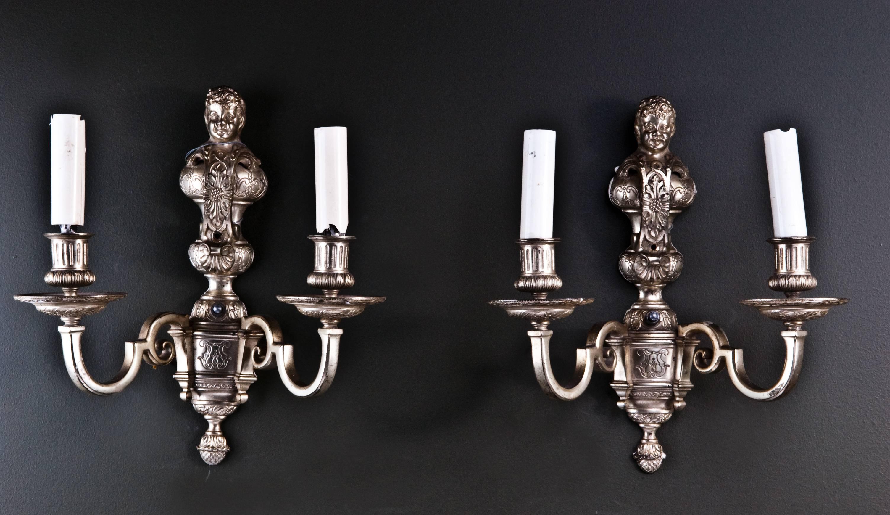 A pair of unique antique American Louis XVI style silvered bronze double light figural wall sconces attributed to E.F. Caldwell.