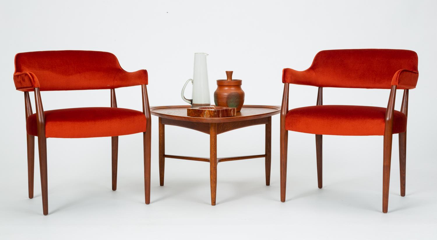 A pair of armchairs by New-York based contract furniture brand J.G. Furniture Co. with walnut frames and striking orange red mohair upholstery. Each chair has a sculpted backrest with tight upholstery and a generously padded seat cushion on matching