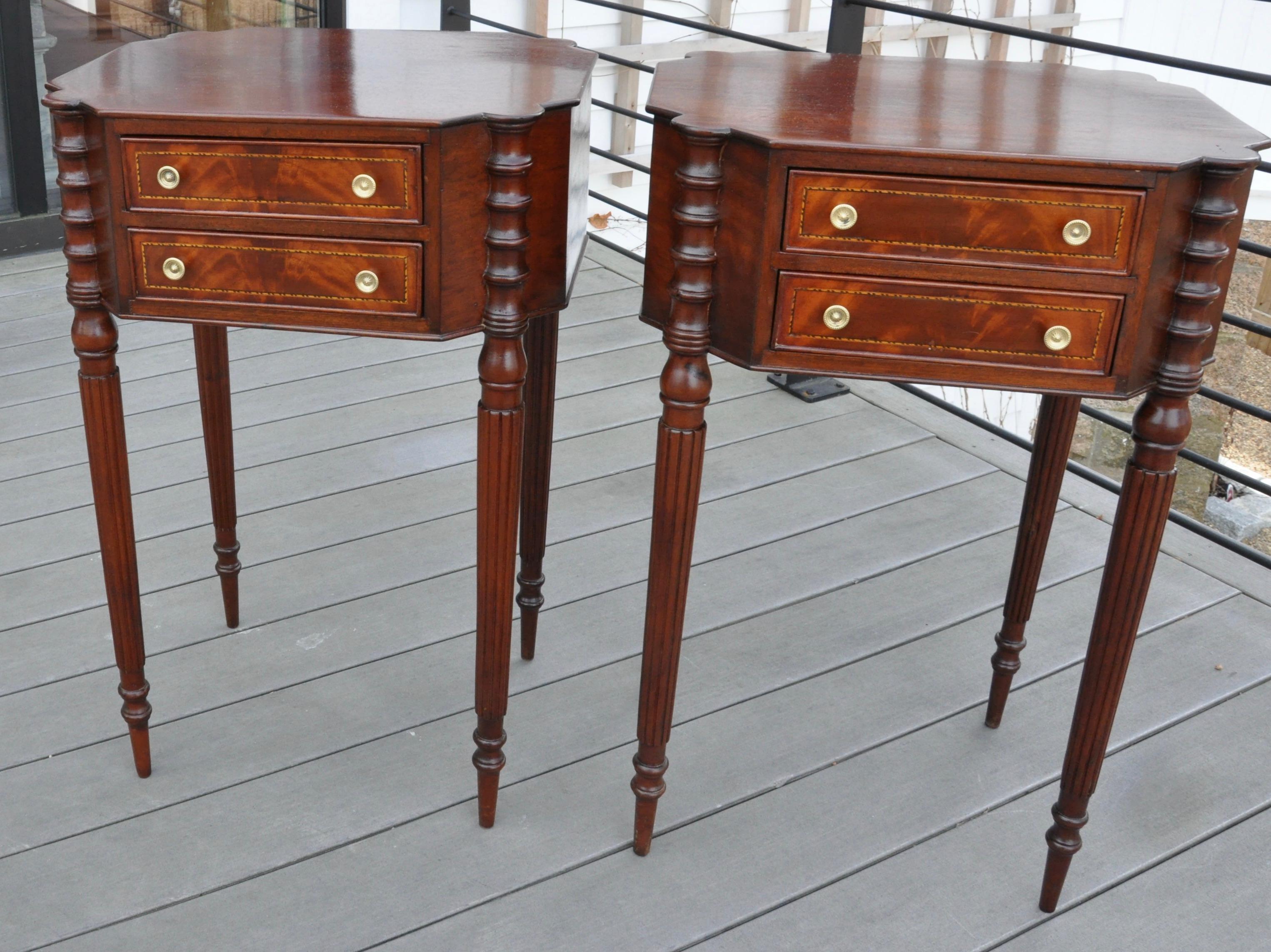 Pair of Federal style work or side tables in the style of McIntire. Two-drawer with reeded legs, string inlay and turned stiles. Mahogany. A beautiful and rare pair.