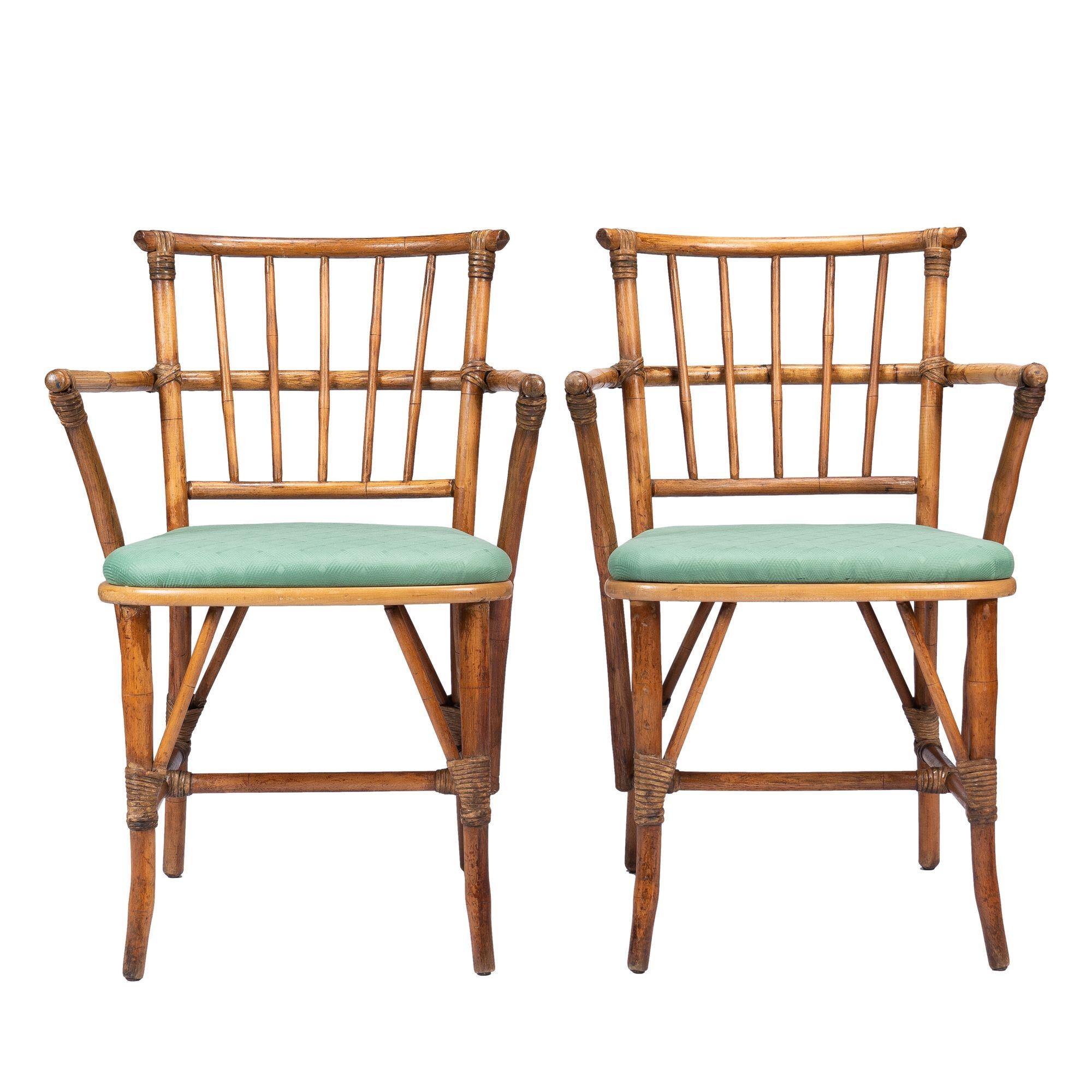 Pair of vintage bamboo turned hardwood arm chairs joined with bamboo lashings and fitted with upholstered seats.
American, mid-20th century.

Dimensions: 22” W x 22-1/2” D x 33” H
19-1/2” (seat height)
15” (rear seat width)
17-1/2” (seat