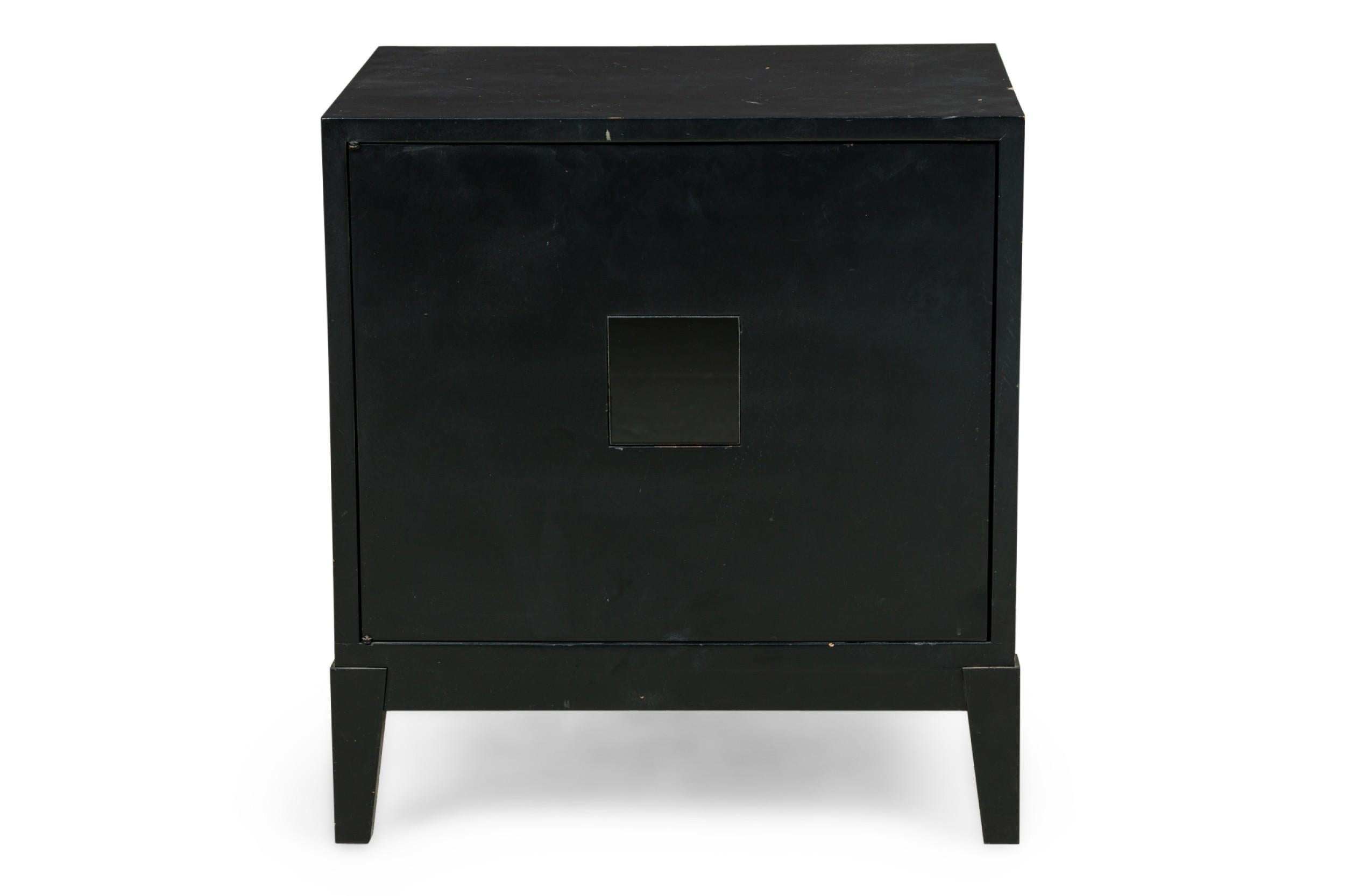 PAIR of American Mid-Century Black matte and shiny lacquer cube shaped bedside commodes / tables with 2 front doors and resting a slightly flaired taped square legs (att: JAMES MONT) (PRICED AS PAIR)
 

Condition: Good; Wear consistent with age and
