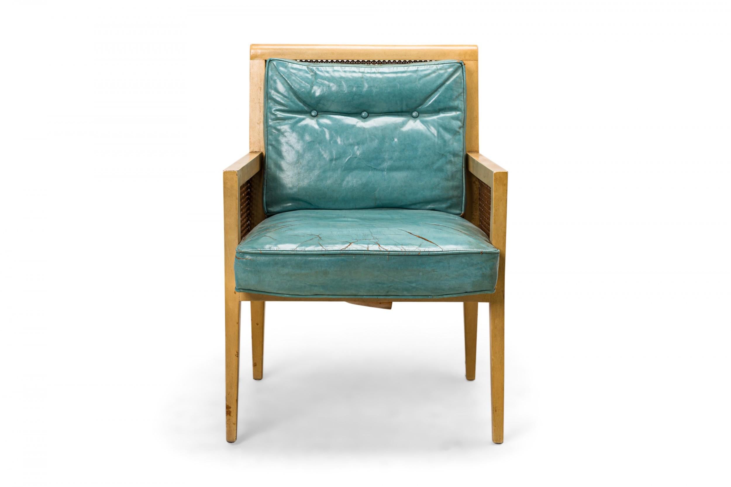 PAIR of American Mid-Century lounge armchairs with blond wood frames, caned sides and backs, and light blue leather upholstered seat and back cushions with button tufted back detail. (PRICED AS PAIR)
