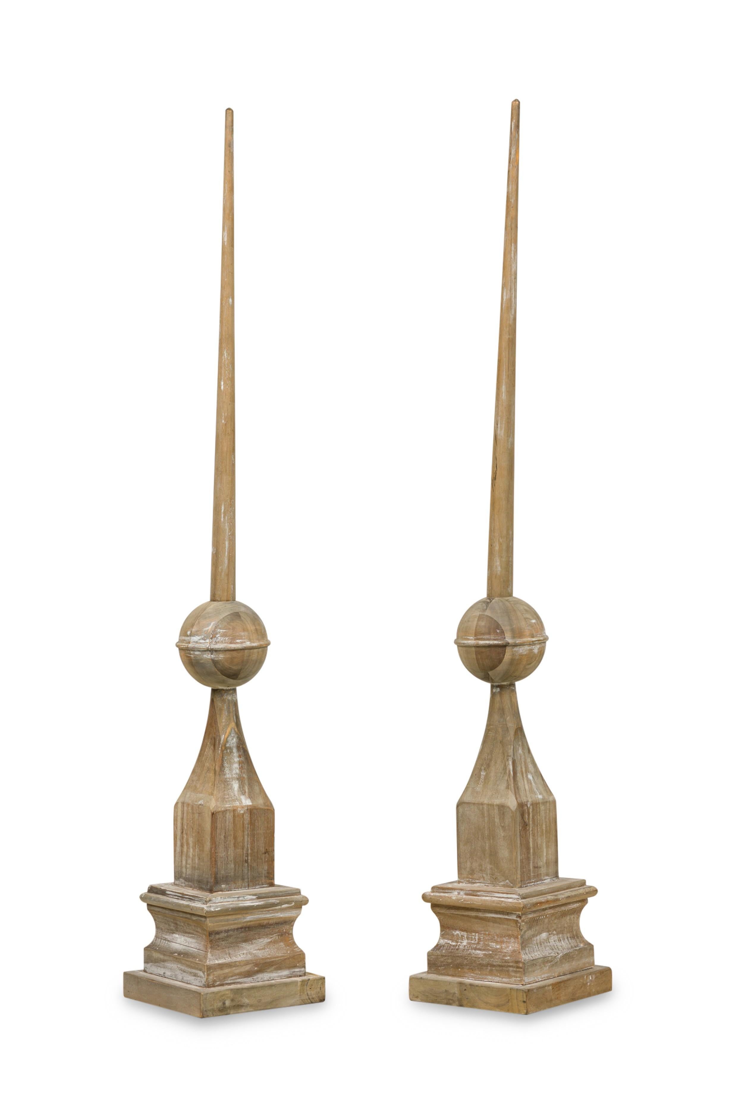 PAIR of American (20th Century) large stripped wood architectual elements having a ball finial top over a bottle form and resting on a square tiered base (PRICED AS PAIR)
 

 Condition: Good; Wear consistent with age and use