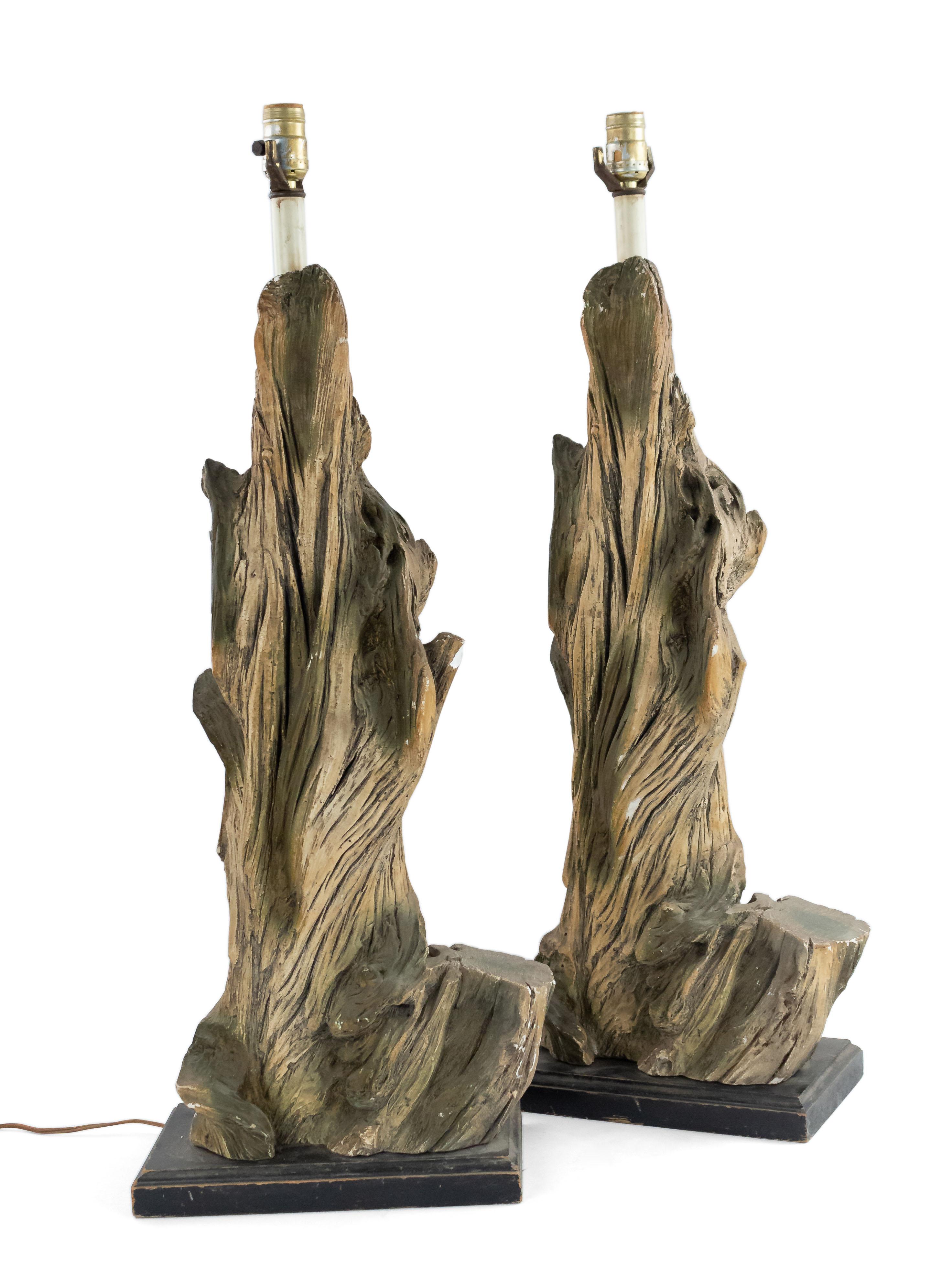 Pair of American Mid-Century large faux driftwood composition table lamps resting on a black rectangular base (PRICED AS Pair).

