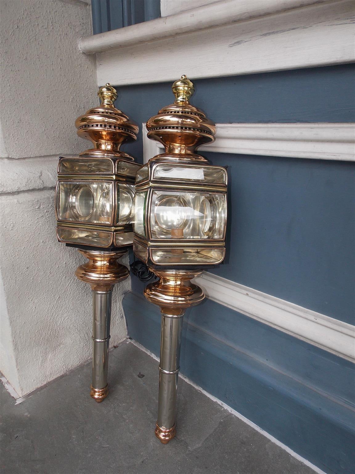 Pair of American nickel silver, brass, and copper coach lanterns with circular bulbous vented finials, original bowed beveled glass, and terminating on turned ringed bulbous reservoirs. Mid-19th century. Signed English and Mersick, New Haven, CT.