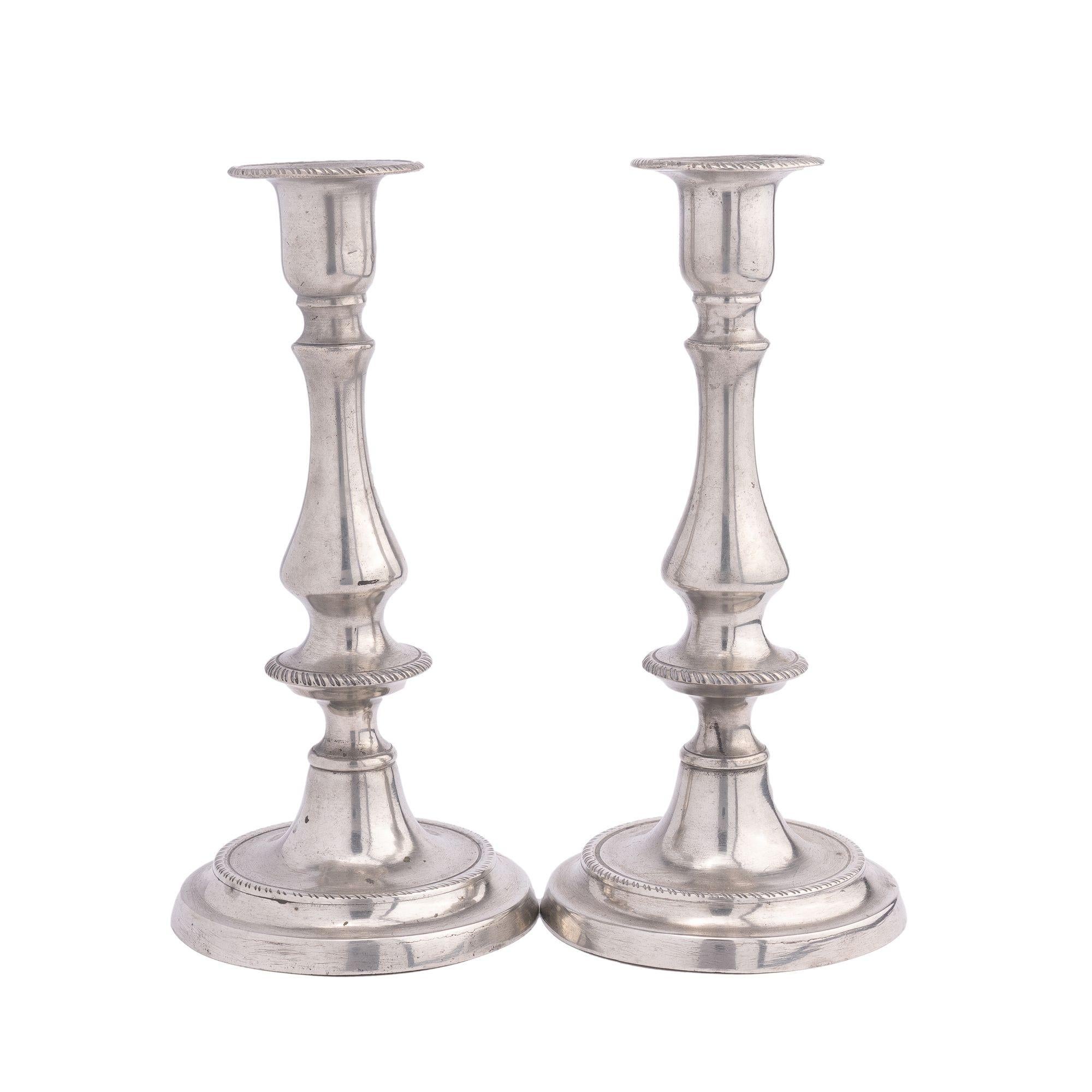 Pair of baluster form pewter candlesticks with roped edged bobesh and candle push-up ejectors.
American, circa 1820-1830.