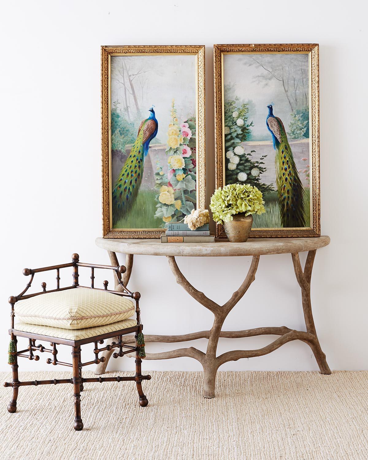 Gorgeous pair of early 20th century American school peacock paintings. Beautifully set in a floral landscape with bright vivid colors. Mounted in giltwood frames. Each canvas measures 35.5 inches high by 17.5 inches wide. Frames show signs of wear