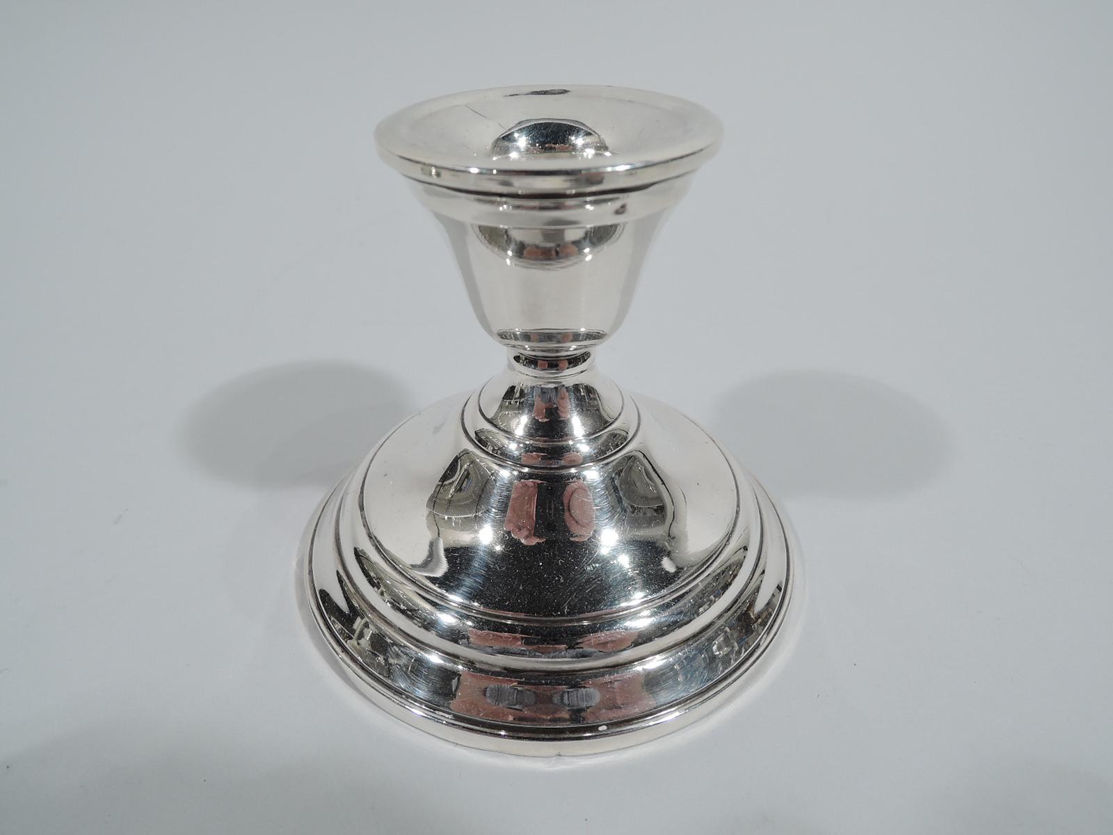 Pair of sterling silver low candlesticks. Made by Watrous (a division of International) in Wallingford, Conn. Tapering socket on stepped and domed foot. A handy housewarming gift. Fully marked including maker’s stamp and no. 13E. Weighted.