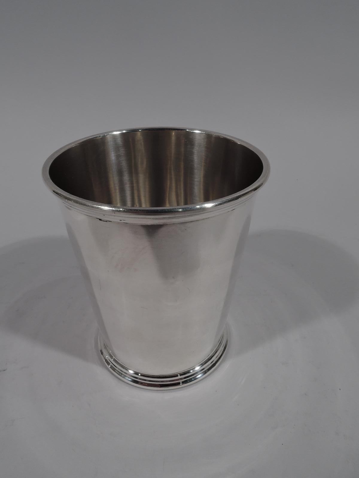 Pair of American sterling silver mint julep cups. Made by S. Kirk & Son in Baltimore. Each: Straight and tapering sides, ribbed rim, and skirted foot. Fully marked including maker’s stamp (1932-61) and no. 277. Total weight: 7.5 troy ounces.
