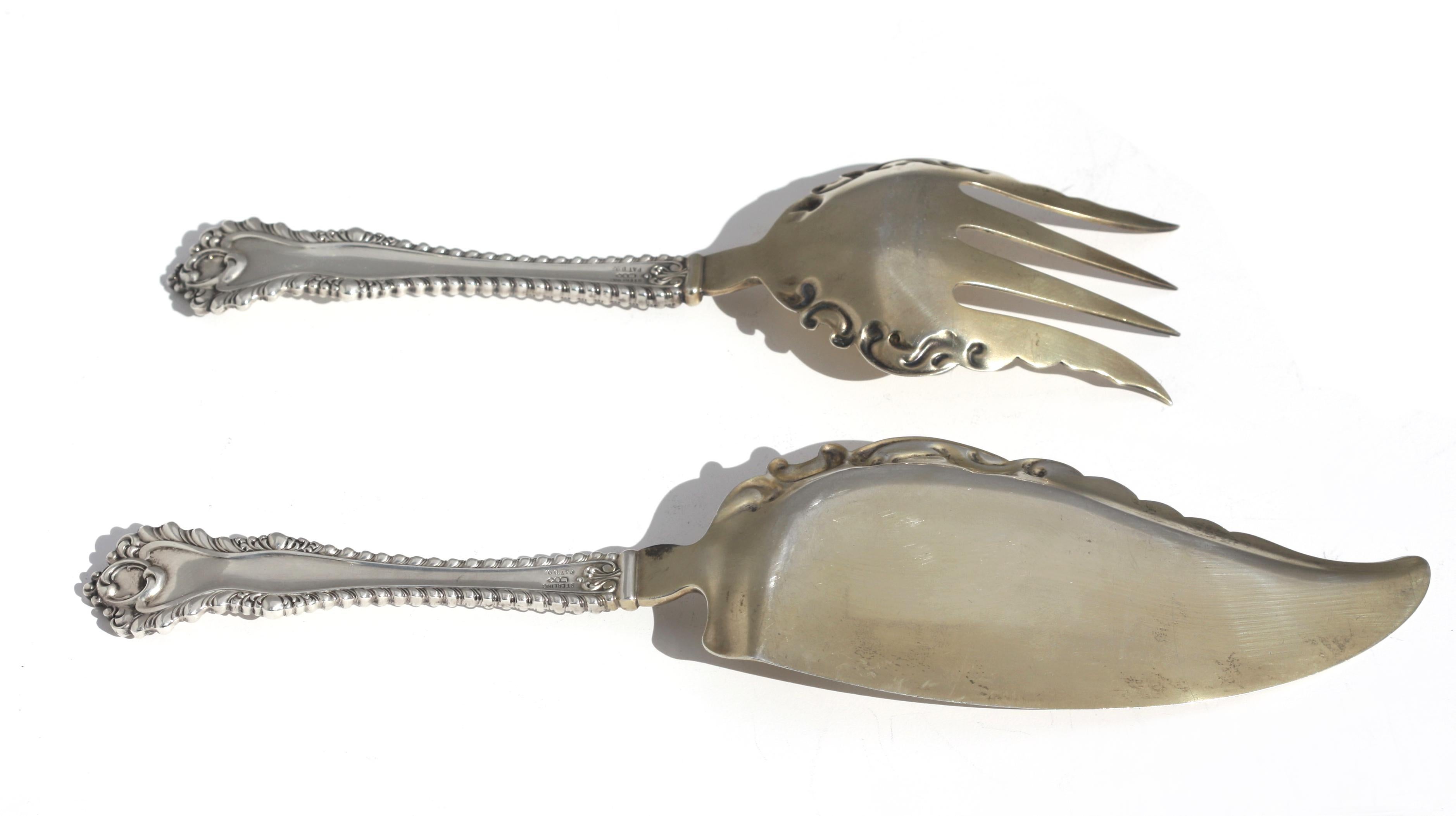 
Pair of American Sterling Silver Serving Pieces
Early to mid-20th Century. Marked Sterling, Pat. D92, with three open geometric-shaped cartouches. Comprising a fork and a fish/cake slice, with remnants of a partially gilt wash.
Length 8.5 in., 11