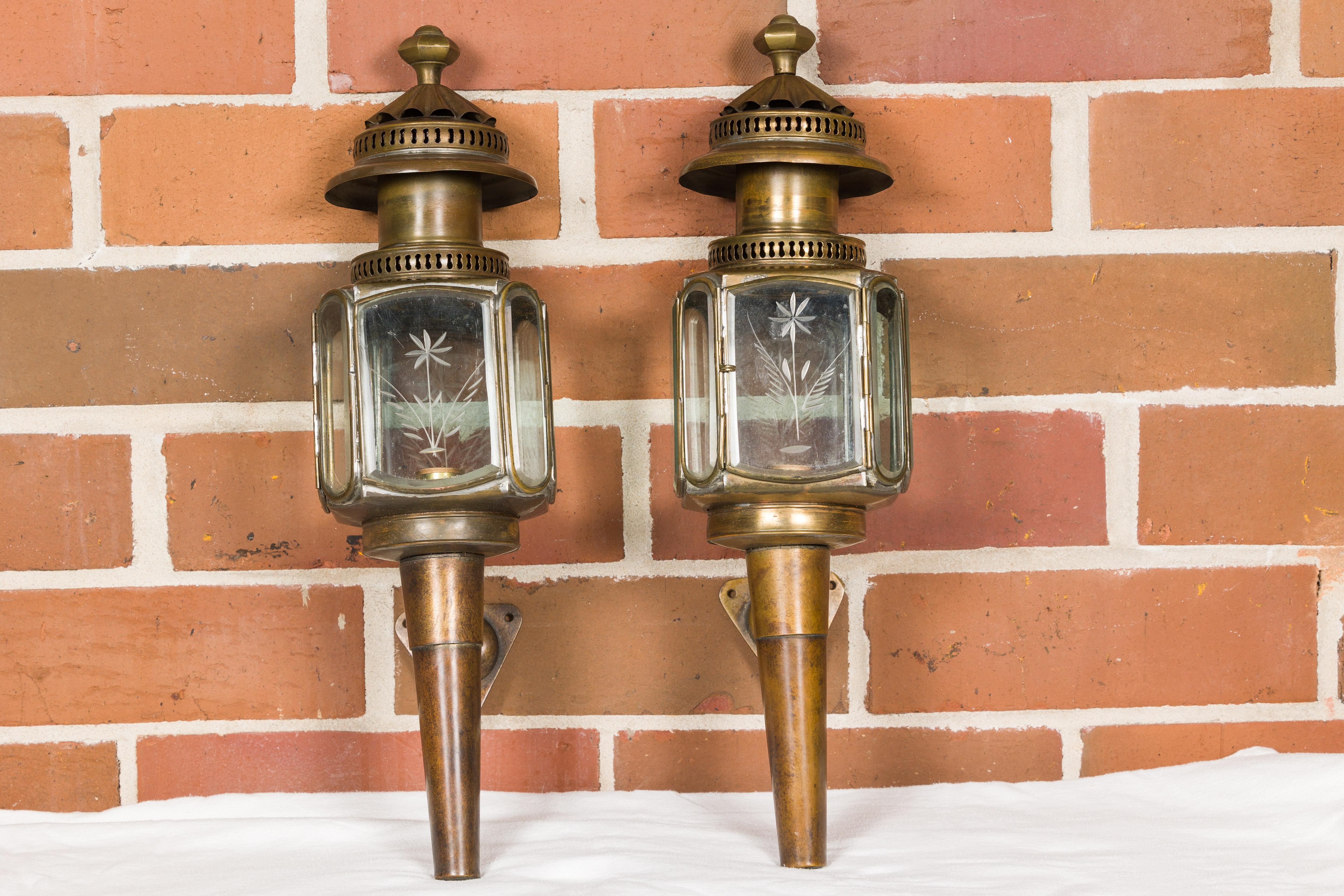 A pair of American Turn of the Century wall lanterns from circa 1900 with etched glass panels. Enrich your home's exterior with the captivating elegance of this pair of American Turn of the Century wall lanterns, circa 1900. Their graceful