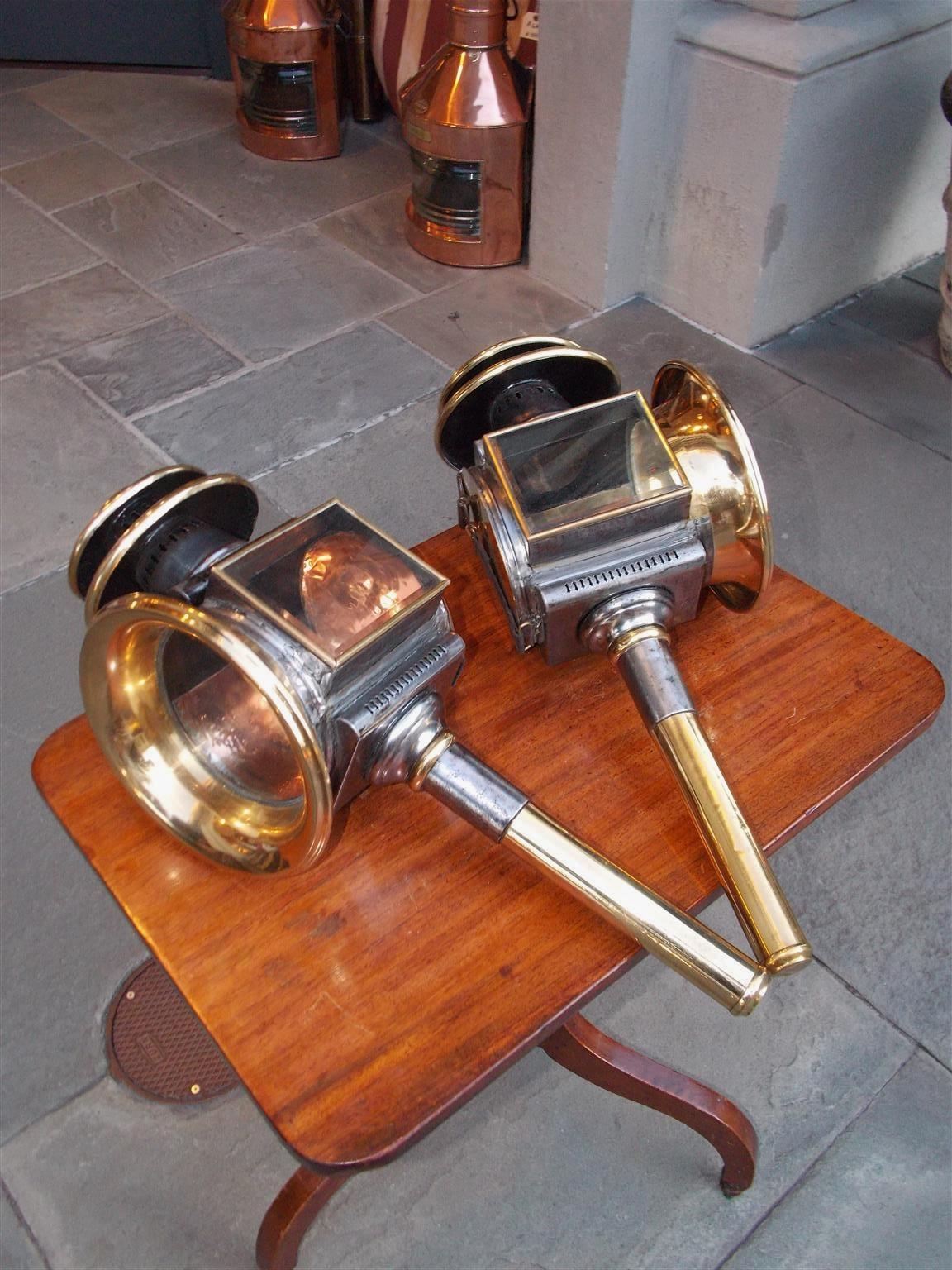 Pair of American two-tiered polished steel and brass coach lanterns with fluted vents and beveled glass, Early 19th century.