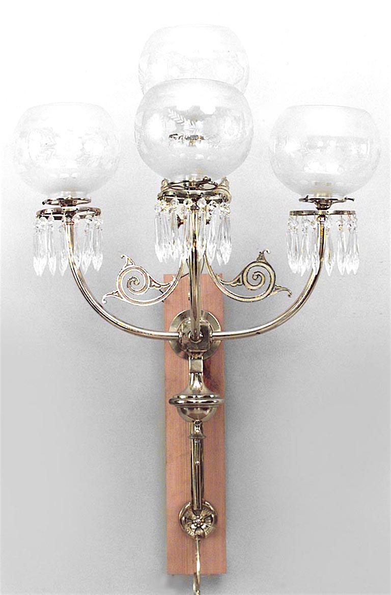 Pair of American Victorian brass wall sconces with three scroll arms and four etched glass globe shades with prism drops. (PRICED AS Pair)
