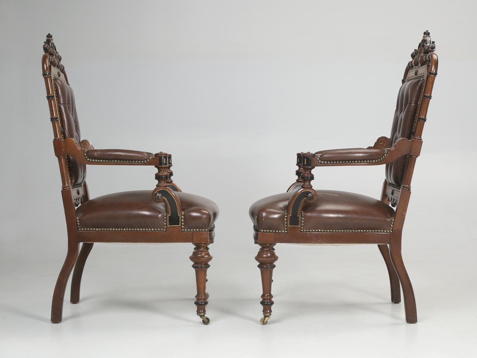 American Eastlake Victorian pair of arm chairs in the most unusual style. We cannot ever remember seeing faux bamboo used in the construction of Eastlake Victorian chairs. There are beautiful inlay details throughout the arm chairs with exquisite