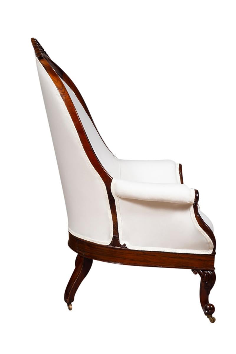Unusual form with arched back with handhold opening and carved detail. Carved cabriole legs. Newly upholstered in muslin.