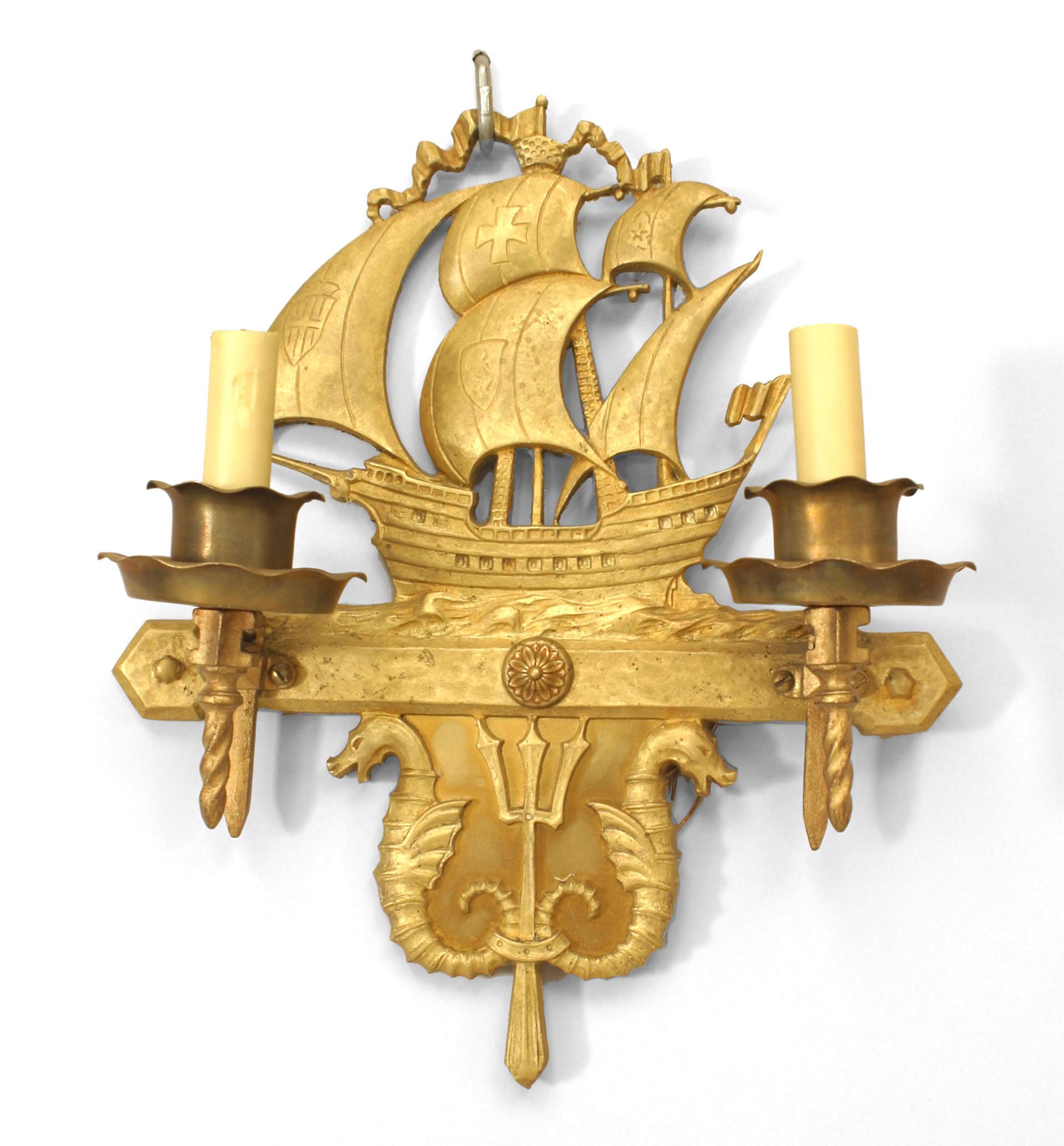 Pair of American Victorian-style (2nd quarter 20th Century) bronze wall sconces with two arms and a nautical motif backplate of ships with sails above two sea horses and a trident. (PRICED AS Pair)
