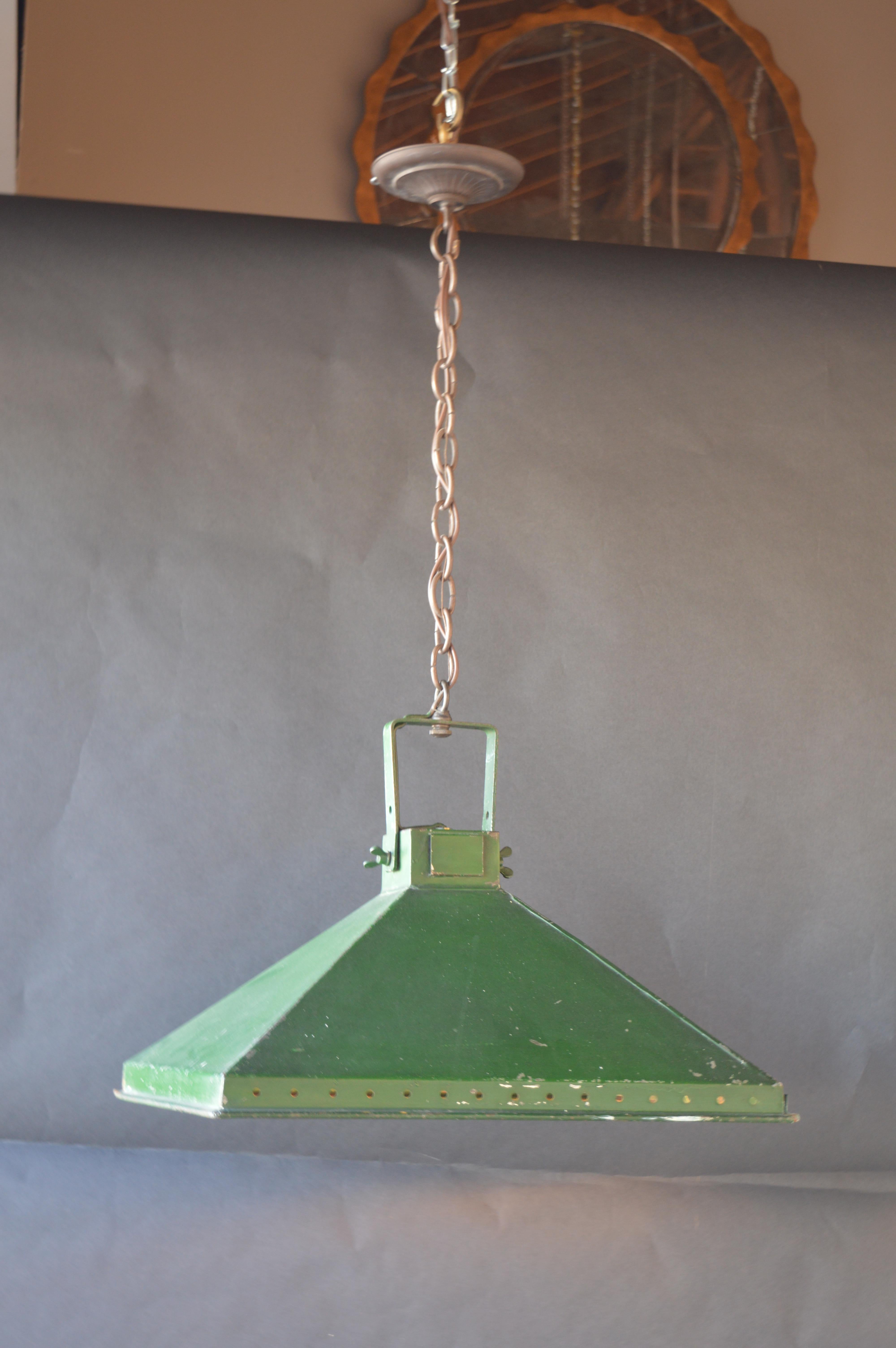 Pair of industrial lanterns painted green. Mirrored inside around the lightbulb.