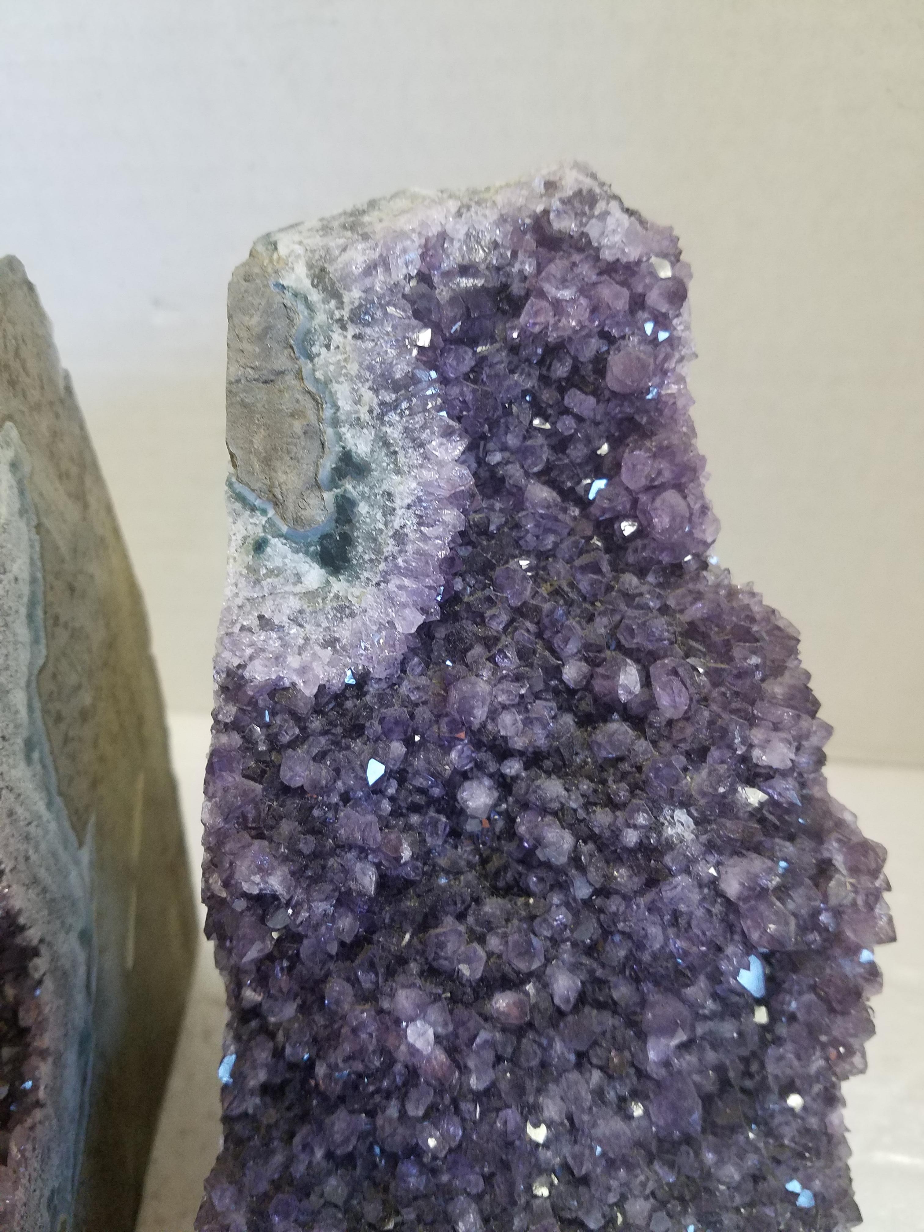 Pair of natural amethyst geodes made into bookends. Beautiful and very faceted with small crystals. See details in photos. Measurement of one side is 4 W x 7 H x 5 D.