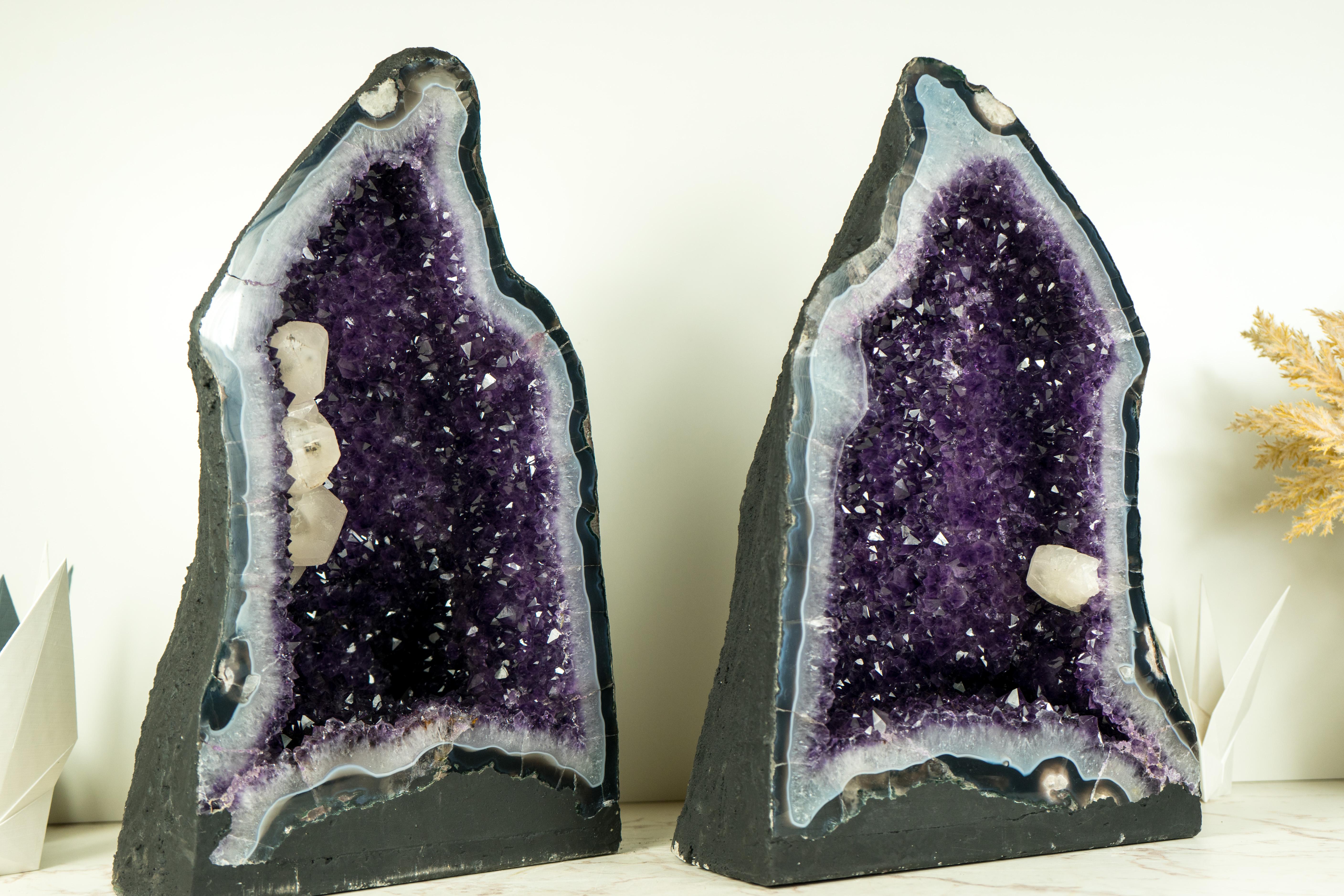 A pair of Amethyst geodes, each standing as an impressive natural sculpture, feature calcite, deep purple and shiny amethyst, and aesthetically pleasing calcite inclusions interlacing, forming a unique display of natural artistry. These centerpiece