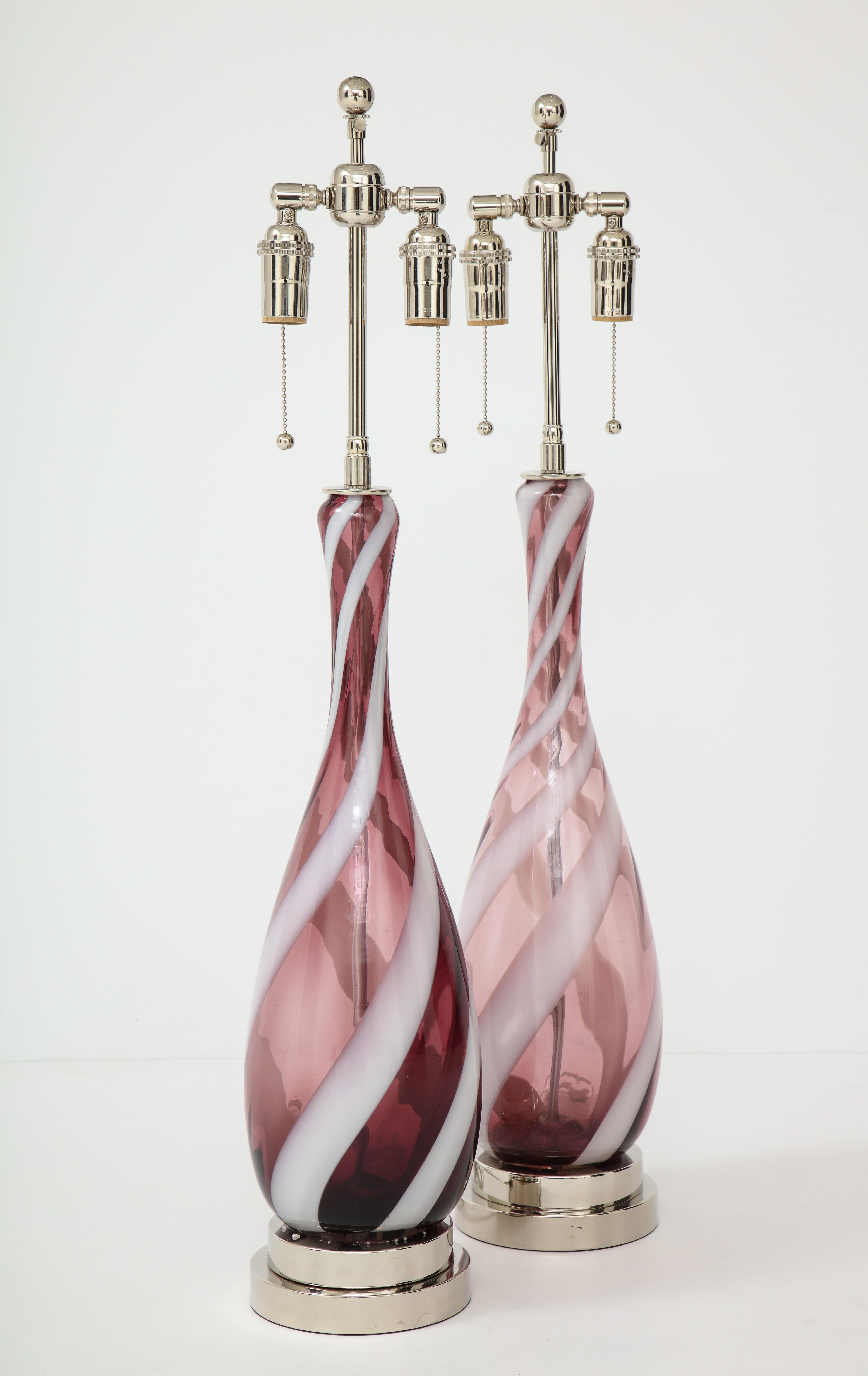 Pair of 1960s amethyst and white Murano glass lamps.
The lamps are mounted on polished stacked nickel bases and they
have been newly rewired with nickel double clusters.