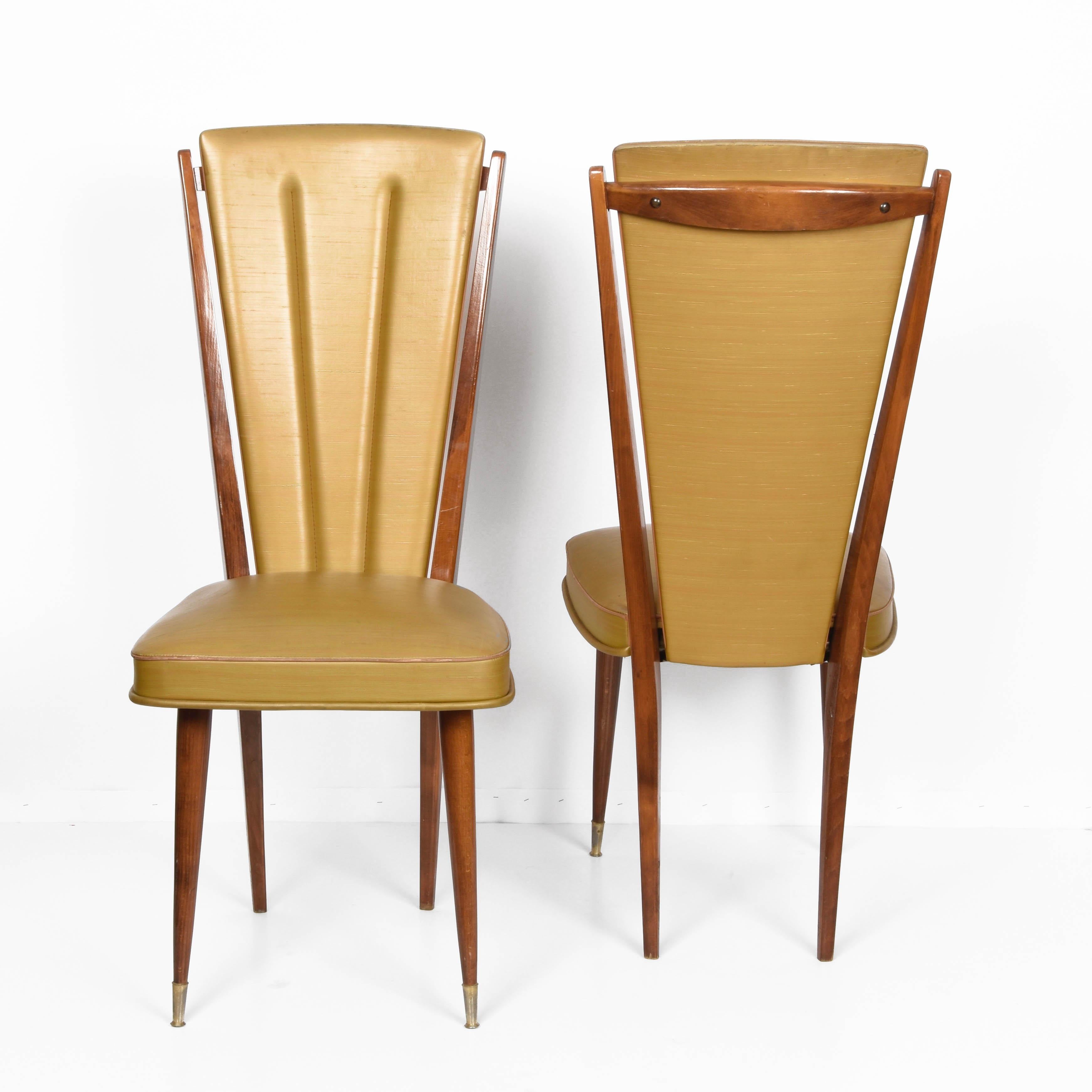 Amazing pair of beech and beige vinyl upholstered dining chairs. These items were produced in France during 1950s by Ameublement NF siege 24.

This set is a major example of French midcentury because of their lines both of the beech structure and