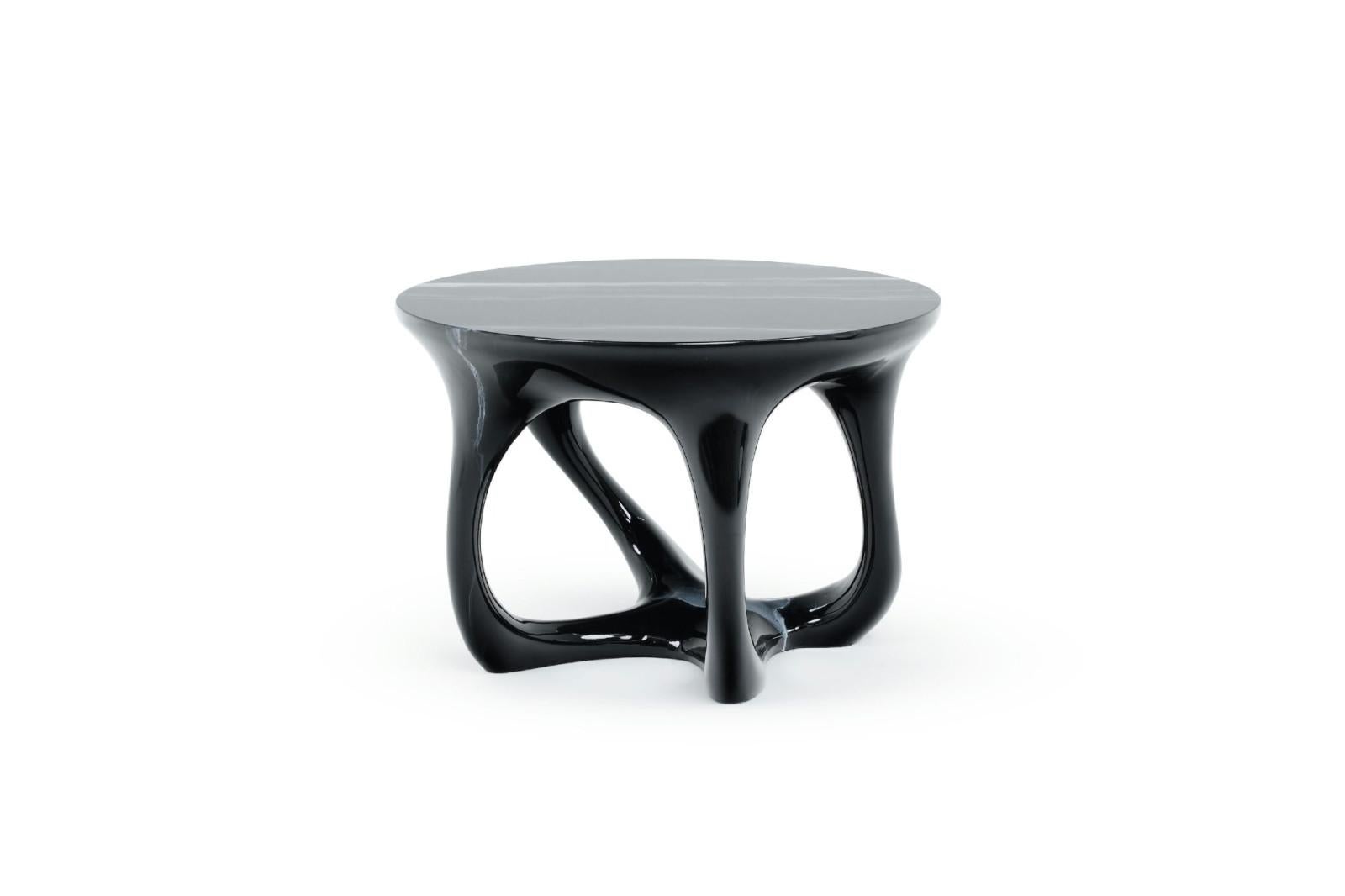 Introducing the Amorph coffee table, where simplicity transforms into a sculptural masterpiece. This side table's distinct form exudes an ethereal allure that transcends the ordinary. With a design that effortlessly captures attention, it stands as