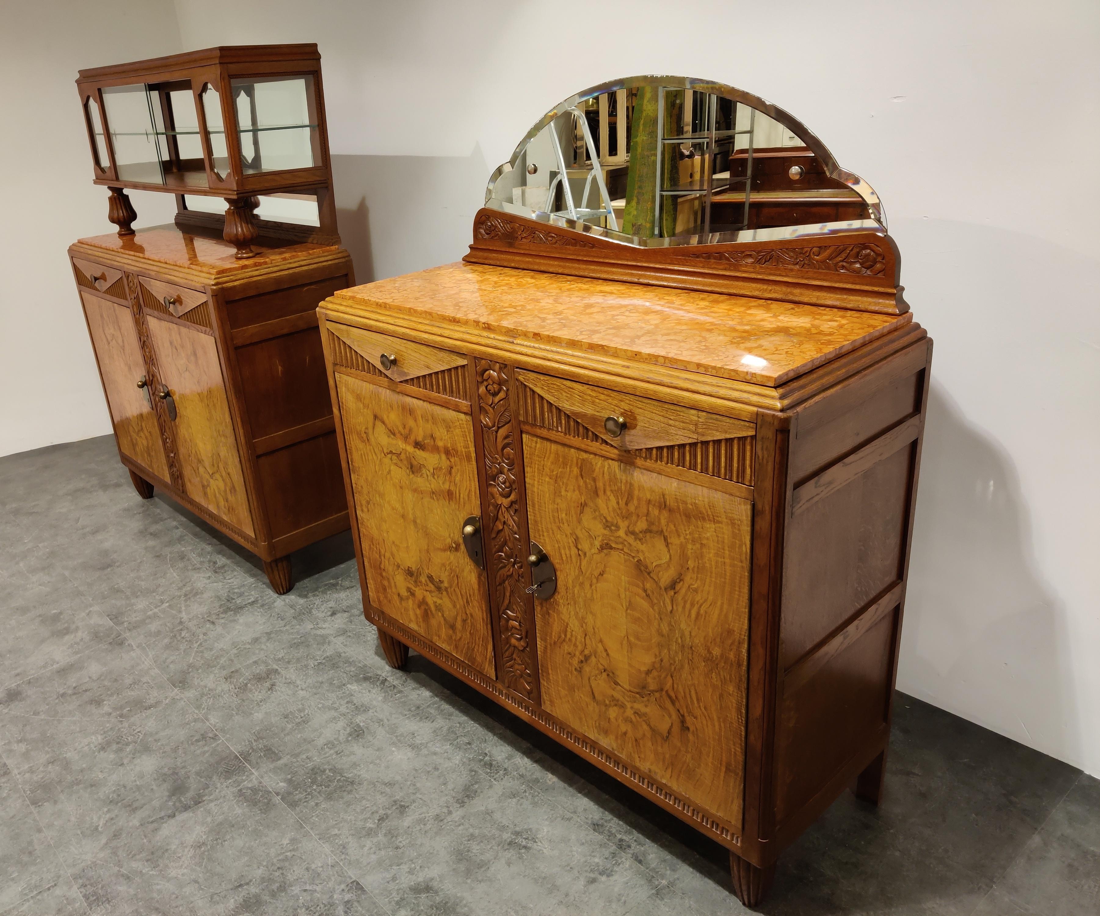 Elegant and beautiful Art Deco 'Amsterdam School' cabinet.

These pieces have many lovely design features, a lot of them typical for Amsterdam School movement.

Beautiful reeded legs, carved flower motive doors, brass handles..

Beautiful use