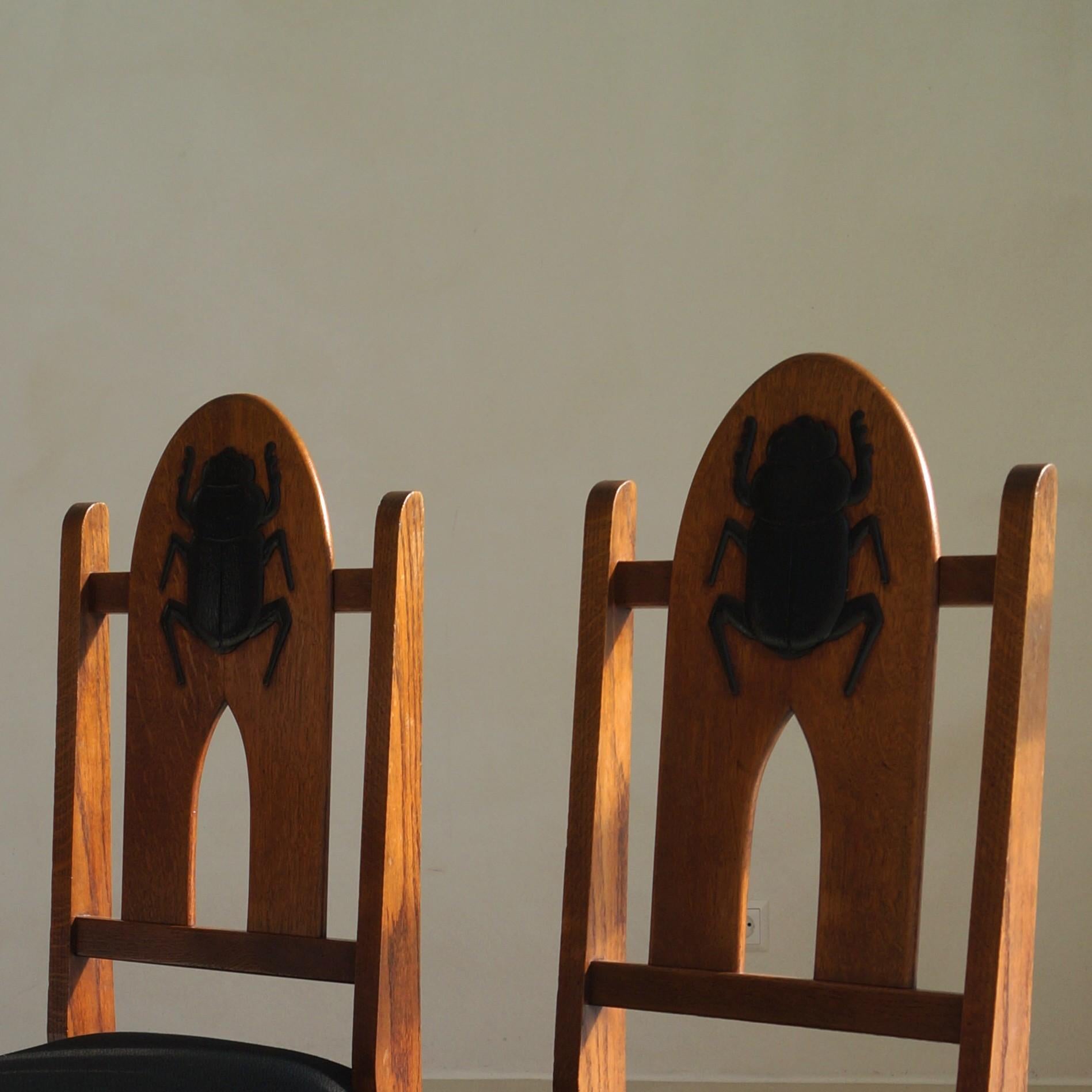 Oak Pair of Amsterdam School Chairs with 'Egyptomania' Scarabs on backrest, c. 1925 For Sale