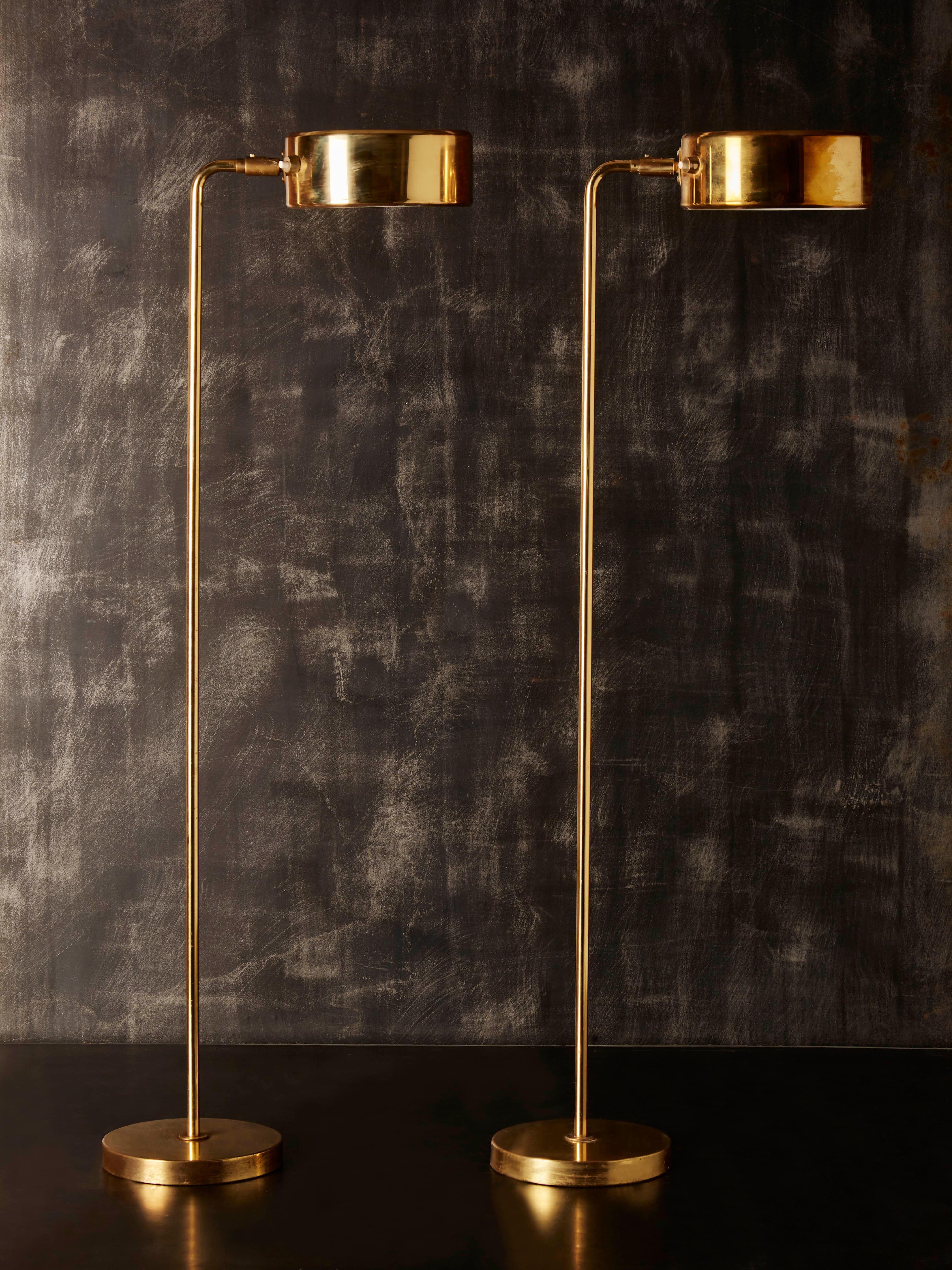 Pair of floor lamps designed by Anders Pehrson for Atelje Lyjktan.

All made in brass, circular foot and sconce with two lights, original sticker.