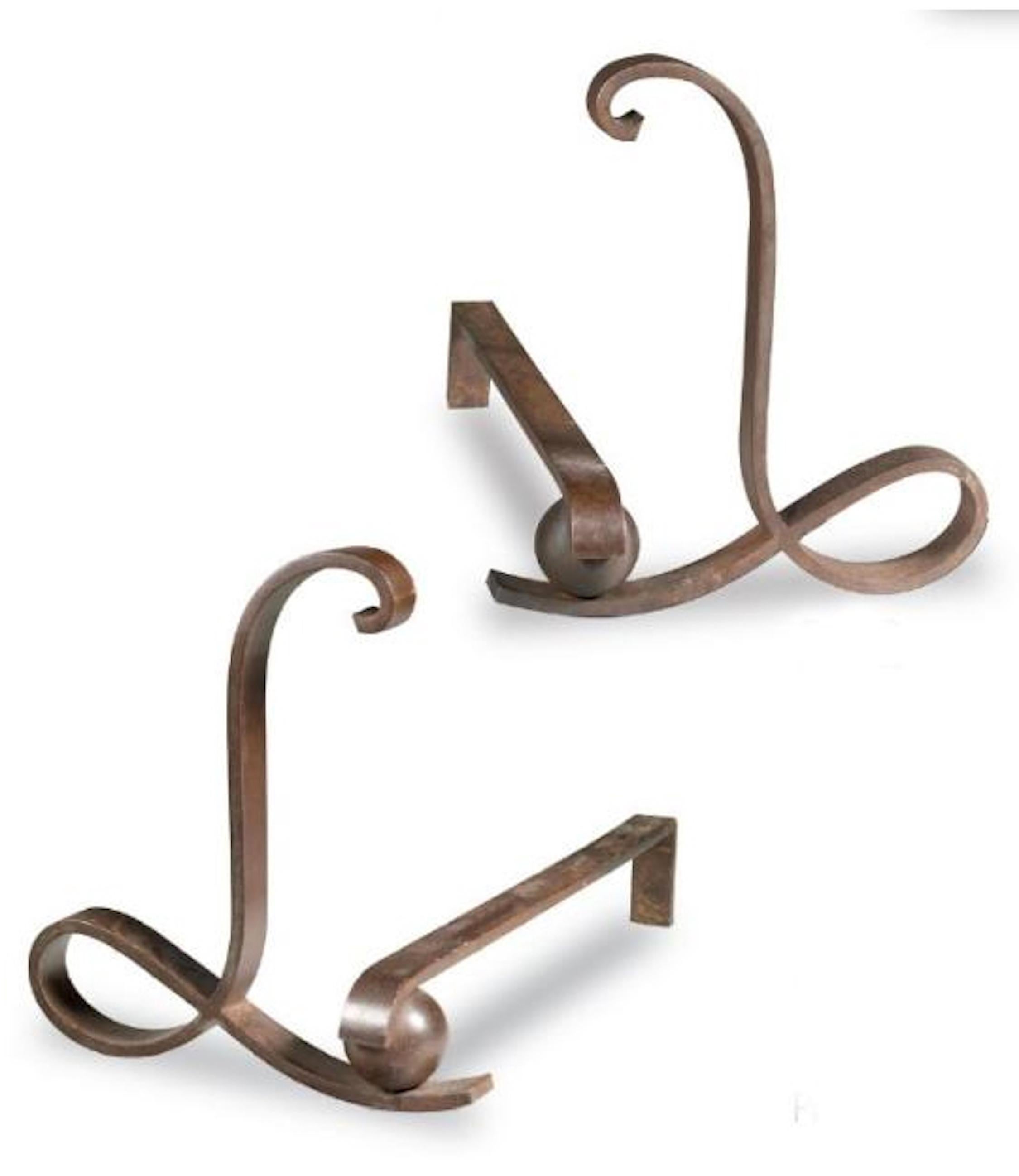 Important wrought iron andirons decorated with a high volute blade, forming an 