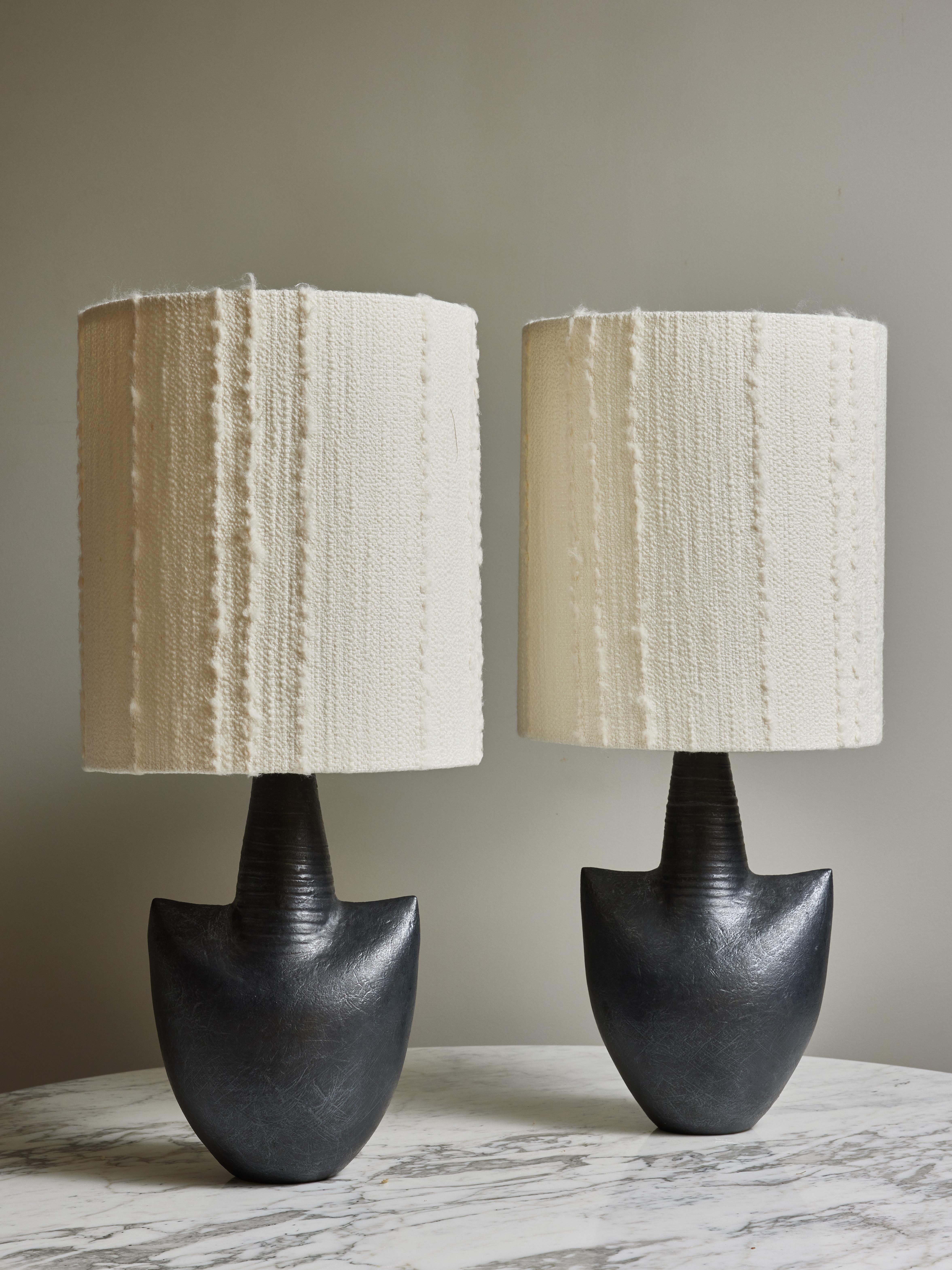 Pair of modern ceramic by Andre Bloch turned into table lamps. Topped with modern lampshade with Nobilis fabric.