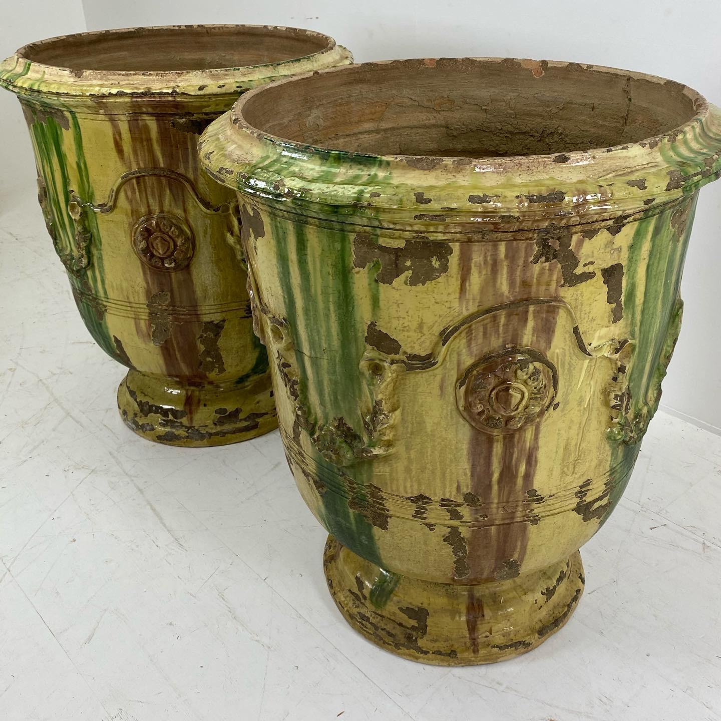 Beautiful pair of Anduze terracotta planters, hand glazed adorned with garlands and medaillons
variation in tone color from green to yellow
great patina.