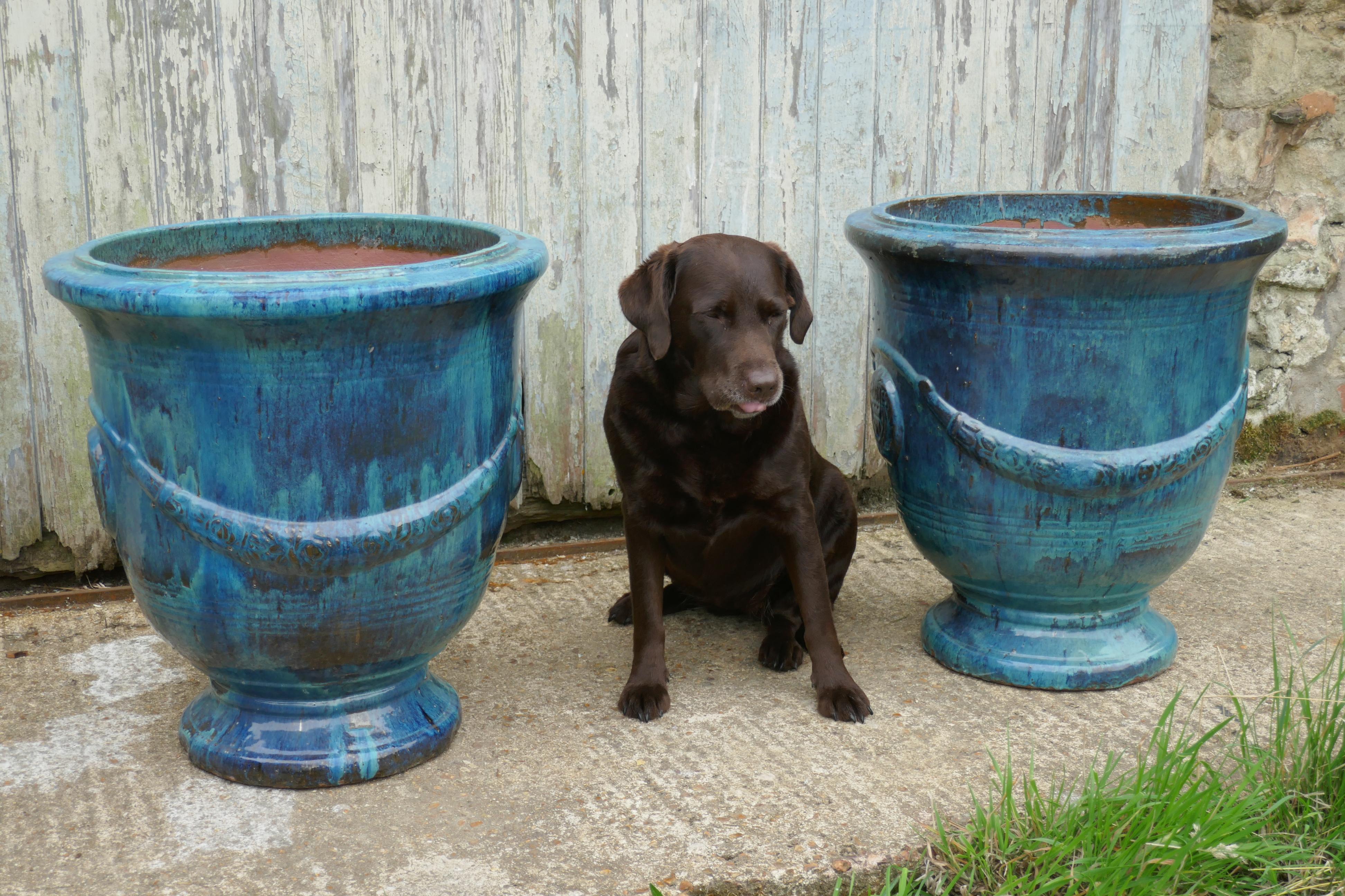 Pair of Anduze terracotta turquoise blue garden urns 

This superb pair of urns were made in the 20th century, they are a copy made by the original Anduze pottery who made the Versailles urns, they are in turquoise blue glaze and fully weather