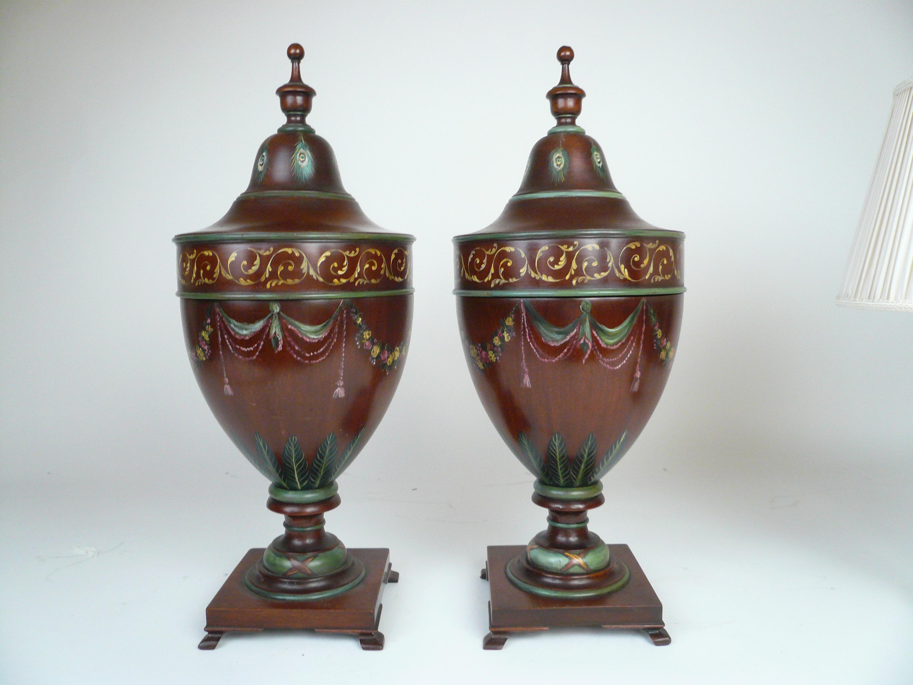 This impressive pair of urn form mahogany knife boxes in the Adam taste are hand painted with Classical motifs including floral swags and acanthus leaves.