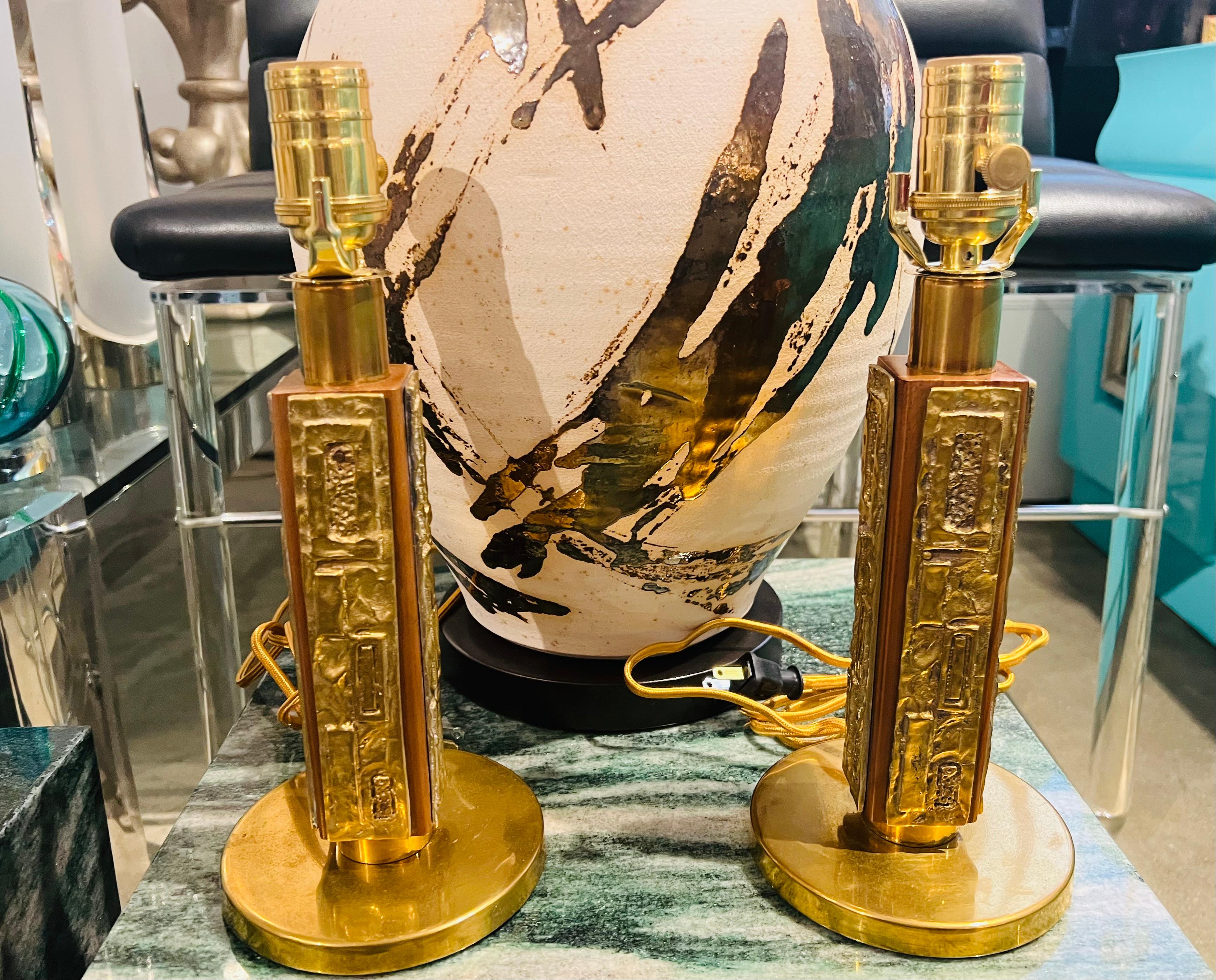 An original pair of Italian 1970s Mid Century table lamps composed of decorative bronze and walnut bodies . Designed by Angelo Brotto for Esperia. Newly rewired with brass sockets and silk cords.