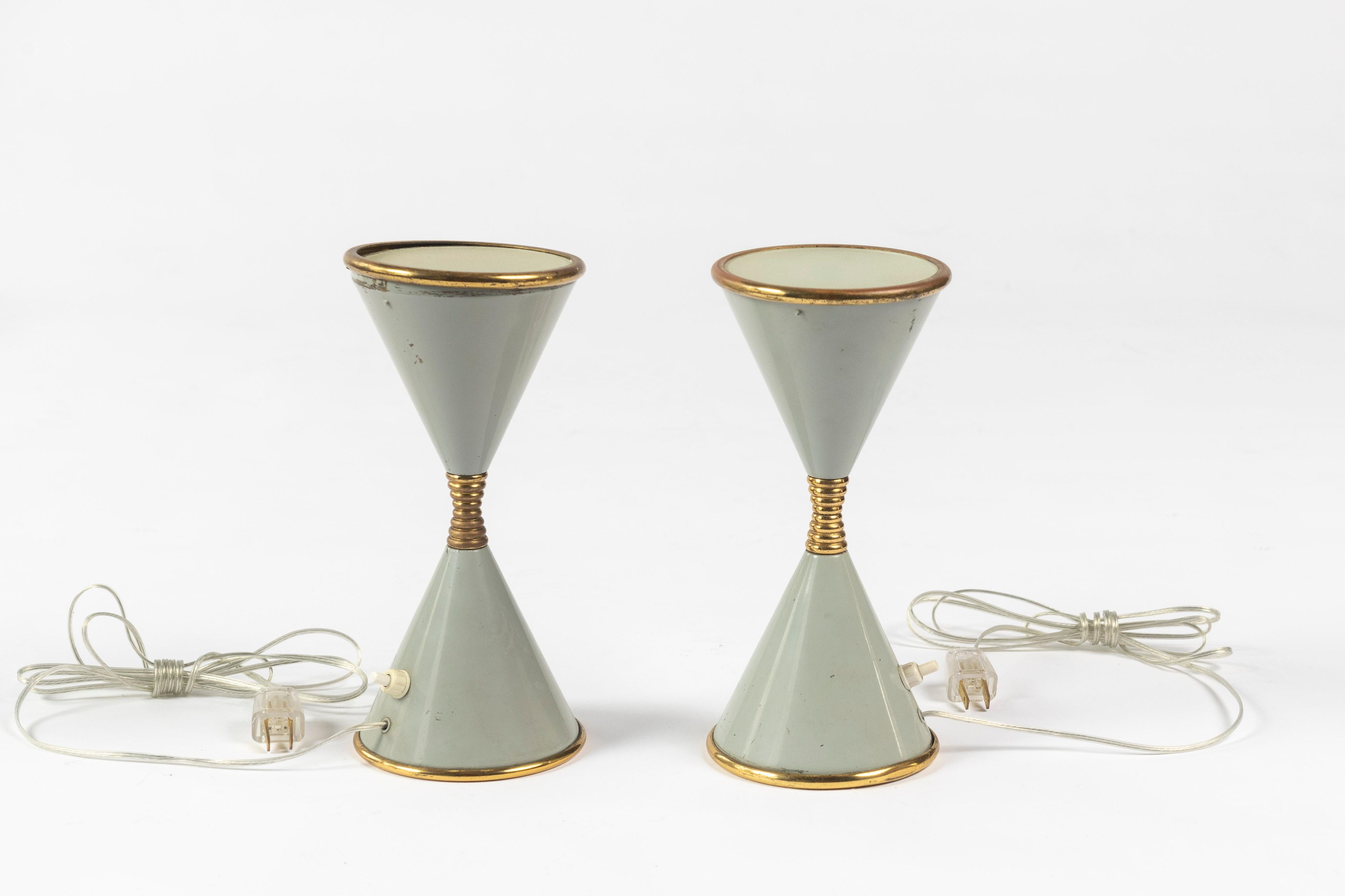 Pair of rare hourglass lamps, designed by Angelo Lelii for Arredoluce, made in the early 1960s. The lamps are sold as a pair and are lacquered brass in a mid-century mint-grey, with frosted glass on the top of the shade.

Some scratches are