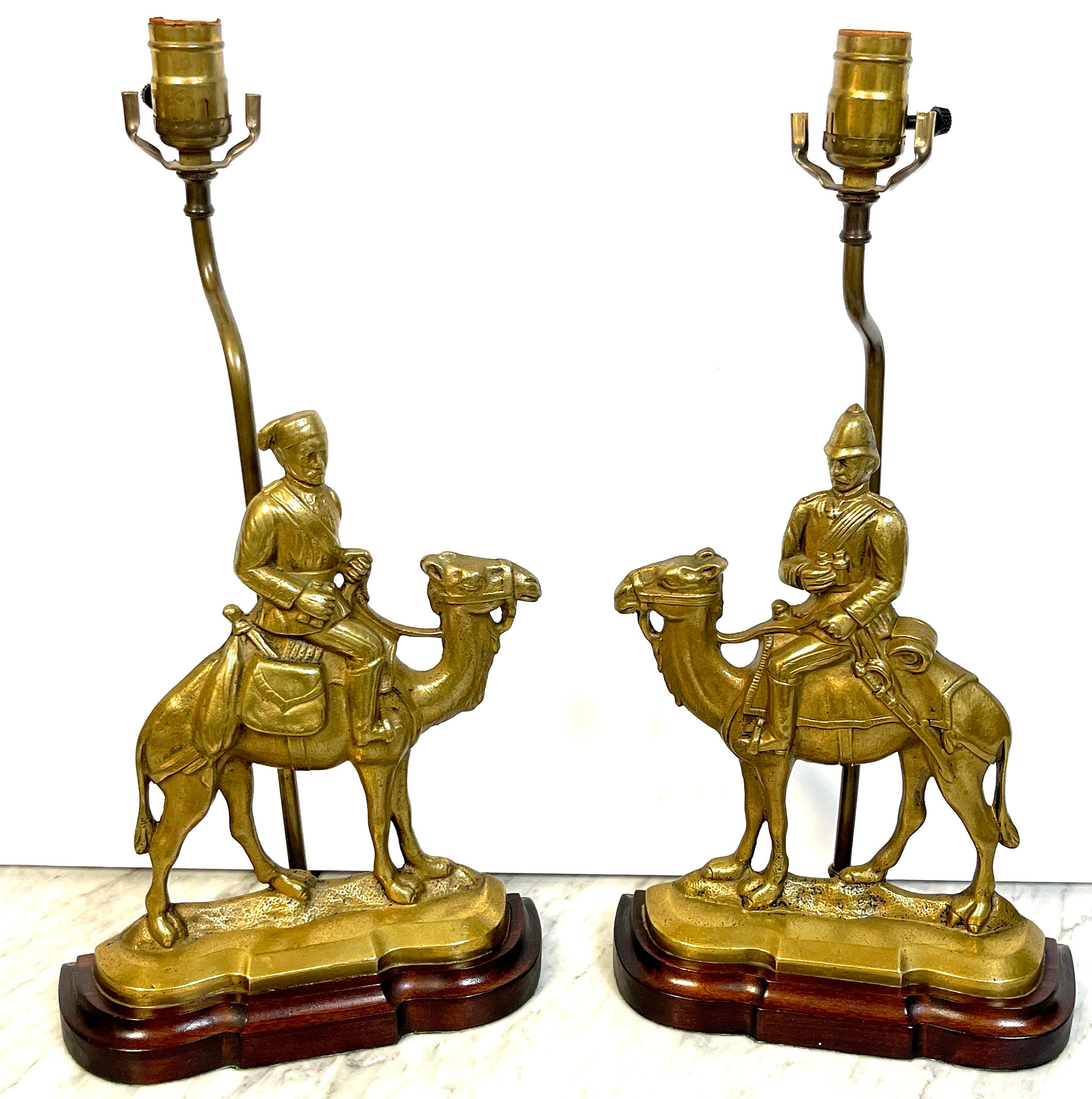 Pair of Anglo-Indian Brass Officer & Camel Doorstops, Now as Lamps 
England, circa 1900s

A rare find a pair of Commemoration Brass Doorstops of 19th century Anglo -Indian officers seated on camels, now mounted as lamps

Overall
