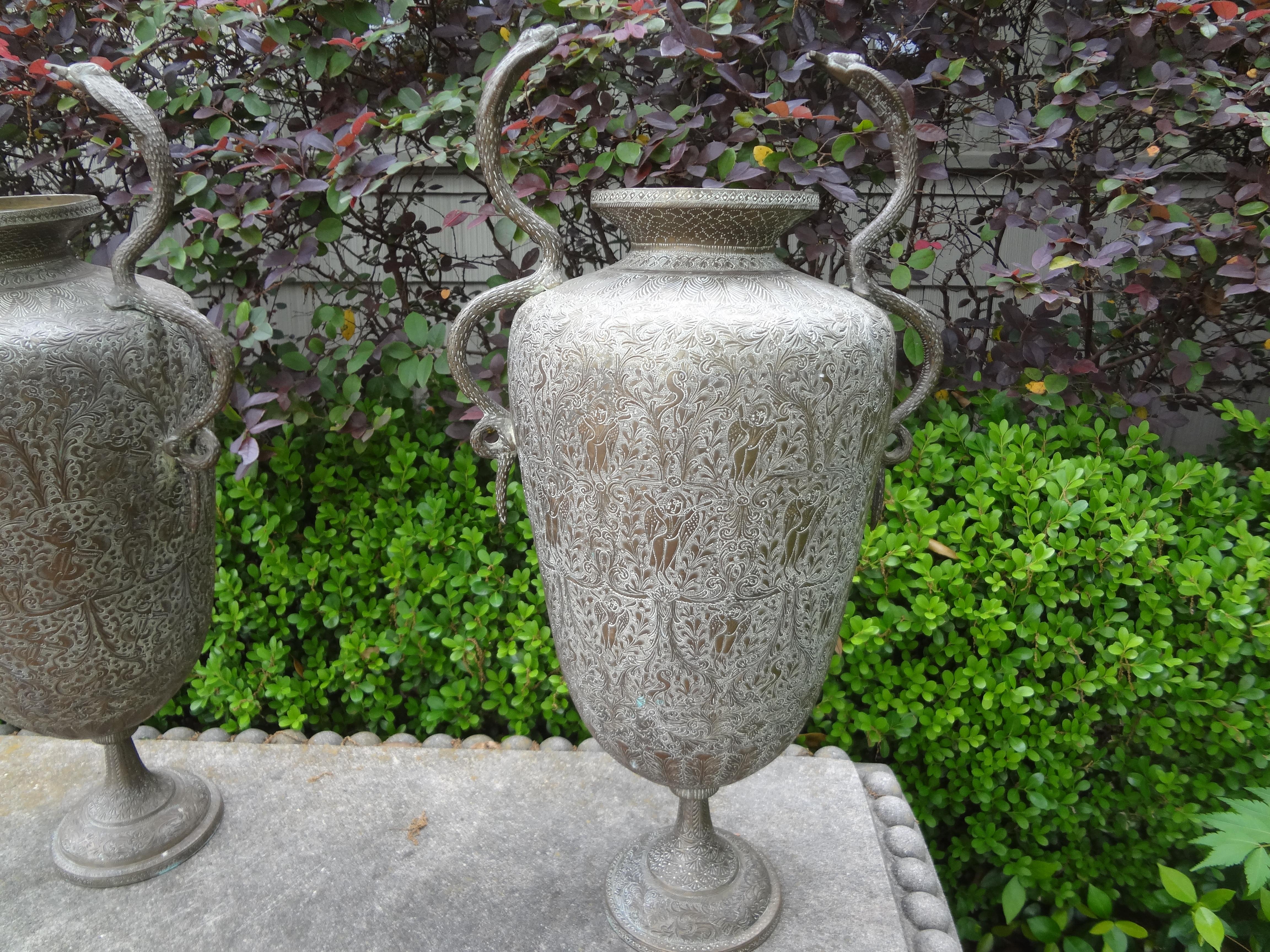 Pair Of Anglo-Indian Brass Urns With Cobras.
This great pair of incised brass urns with cobra handles date to the 1920's India.
Unusual statement accessory.