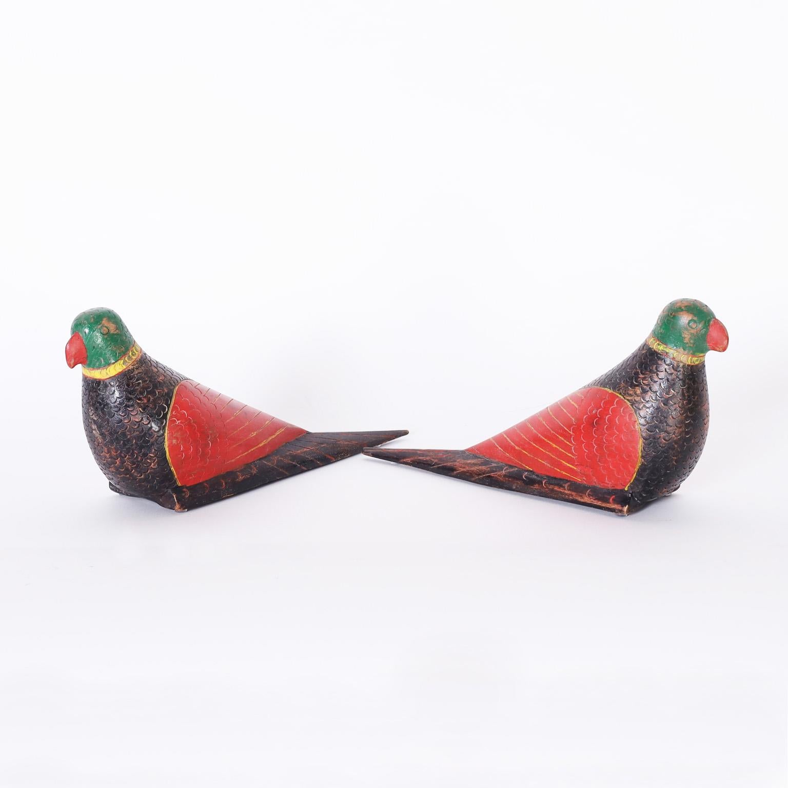 Delightful pair of antique Anglo Indian parrots hand carved from indigenous hardwood and painted in a naive folk style now worn to perfection.