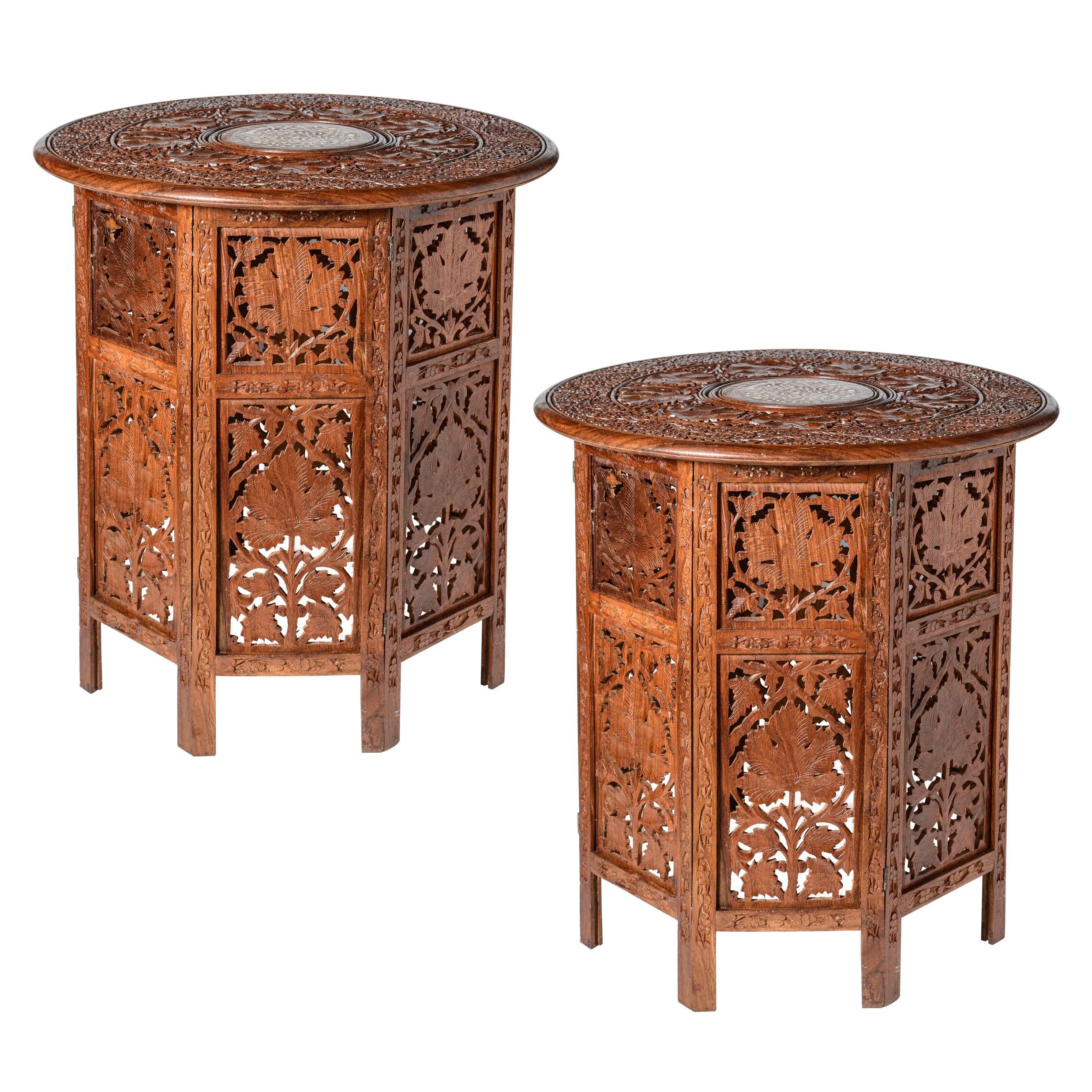Great looking large pair of Anglo Indian Carved Teak Wood Inlay Side Tables, (1920-1960)
This  pair of vintage Anglo Indian tables are crafted in teak wood with round removable tops.
The  tops have   hand carved floral carvings over an octagon base