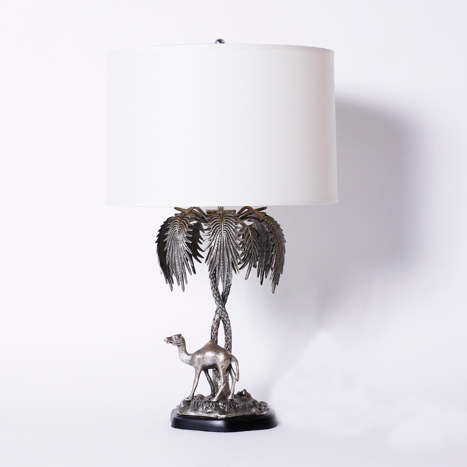 Charming pair of Anglo-Indian silver plate on bronze epergnes mounted as table lamps
depicting an elephant and a camel under palm trees on a patch of terra firma.