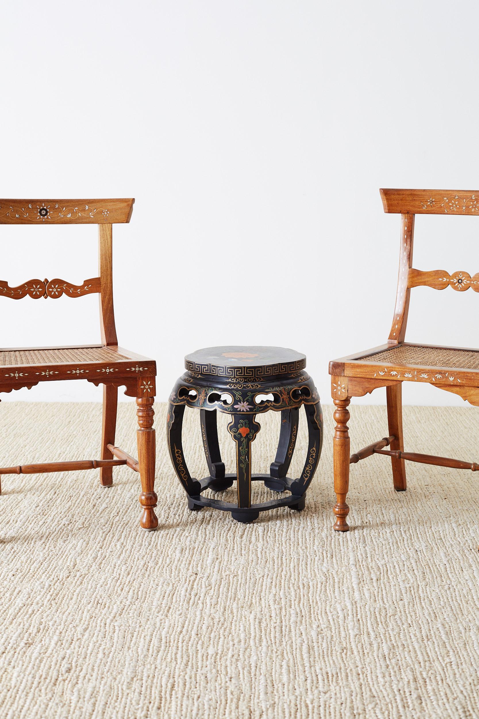Assembled pair of similar Anglo-Indian side chairs made of koa wood. Featuring a floral motif decorative bone inlay and a caned seat. Beautiful grain patterns on the radiant wood of both chairs. Supported by turned legs in the front, one chair is