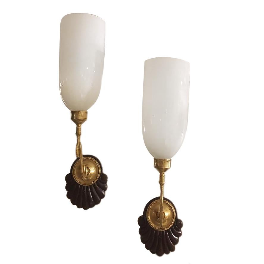 A pair of circa 1900s Anglo-Indian single-light sconces with carved wood backplates and opaline glass hurricanes.

Measurements:
Height 24?
Width 5.5?
Depth 11.5?