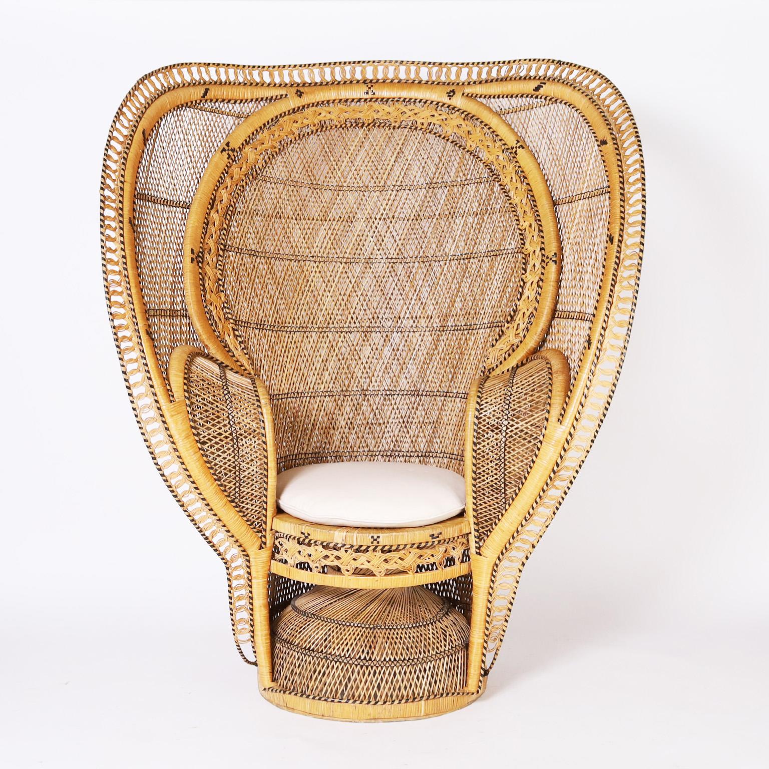 Rare and remarkable pair of Anglo Indian chairs expertly crafted in wicker and reed in a grand form as a peacock chair inside a cobra form outer layer. Best of the genre.
